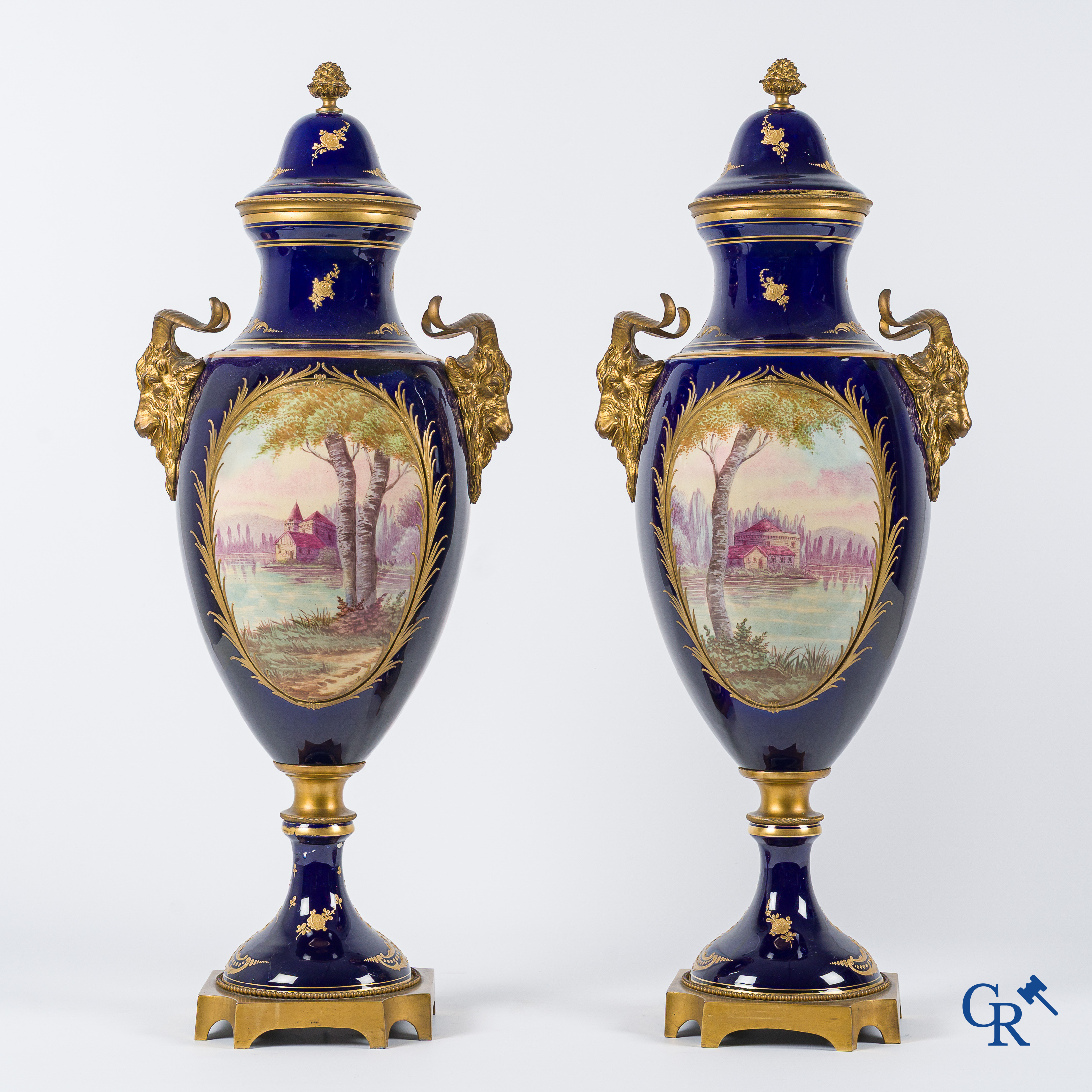 Sèvres. Pair of large decorated cobalt blue vases with bronze fittings and raised gilding. LXVI style. circa 1920.