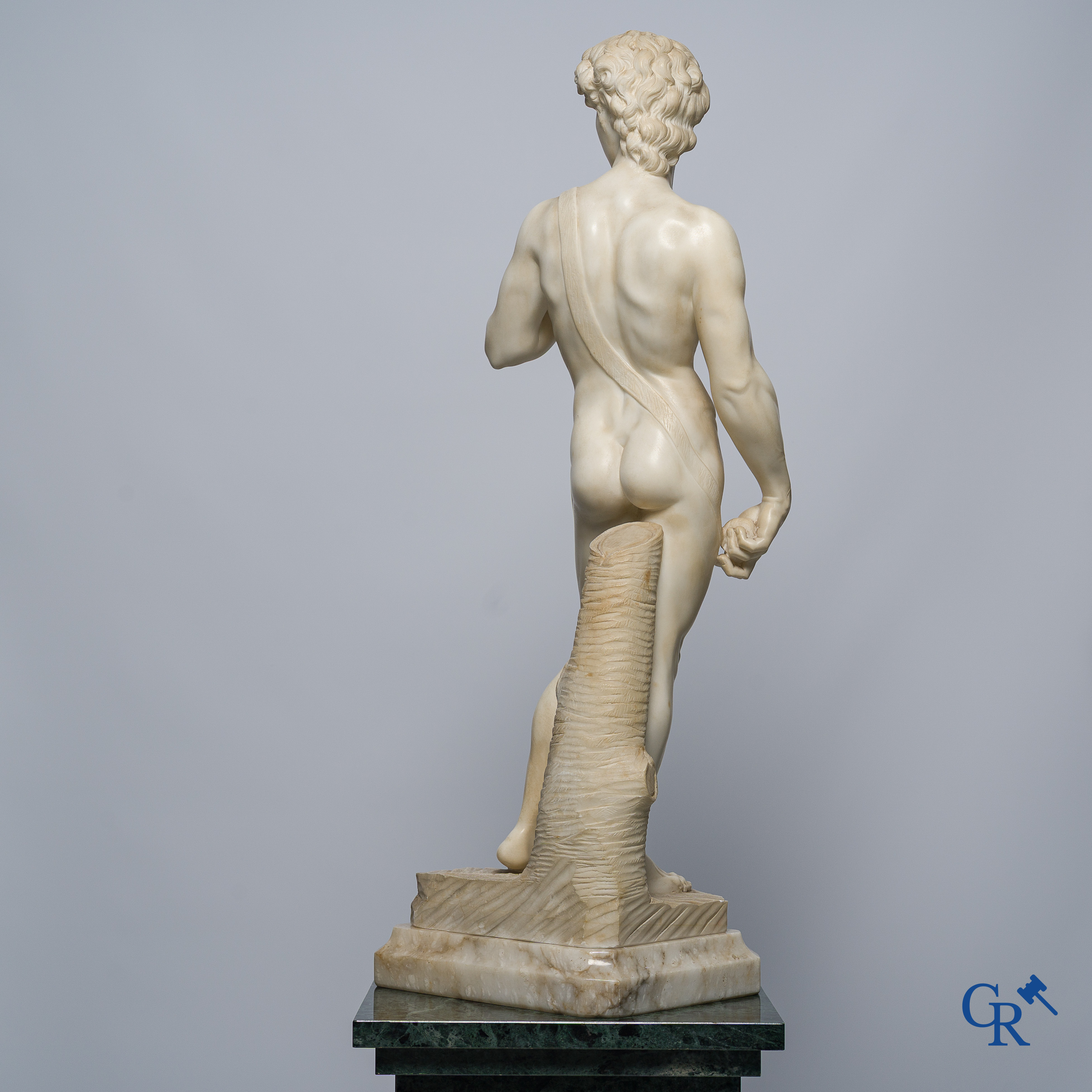 Michelangelo (after) In the antique style. Representation of David in sculpted marble. Mid-20th century.