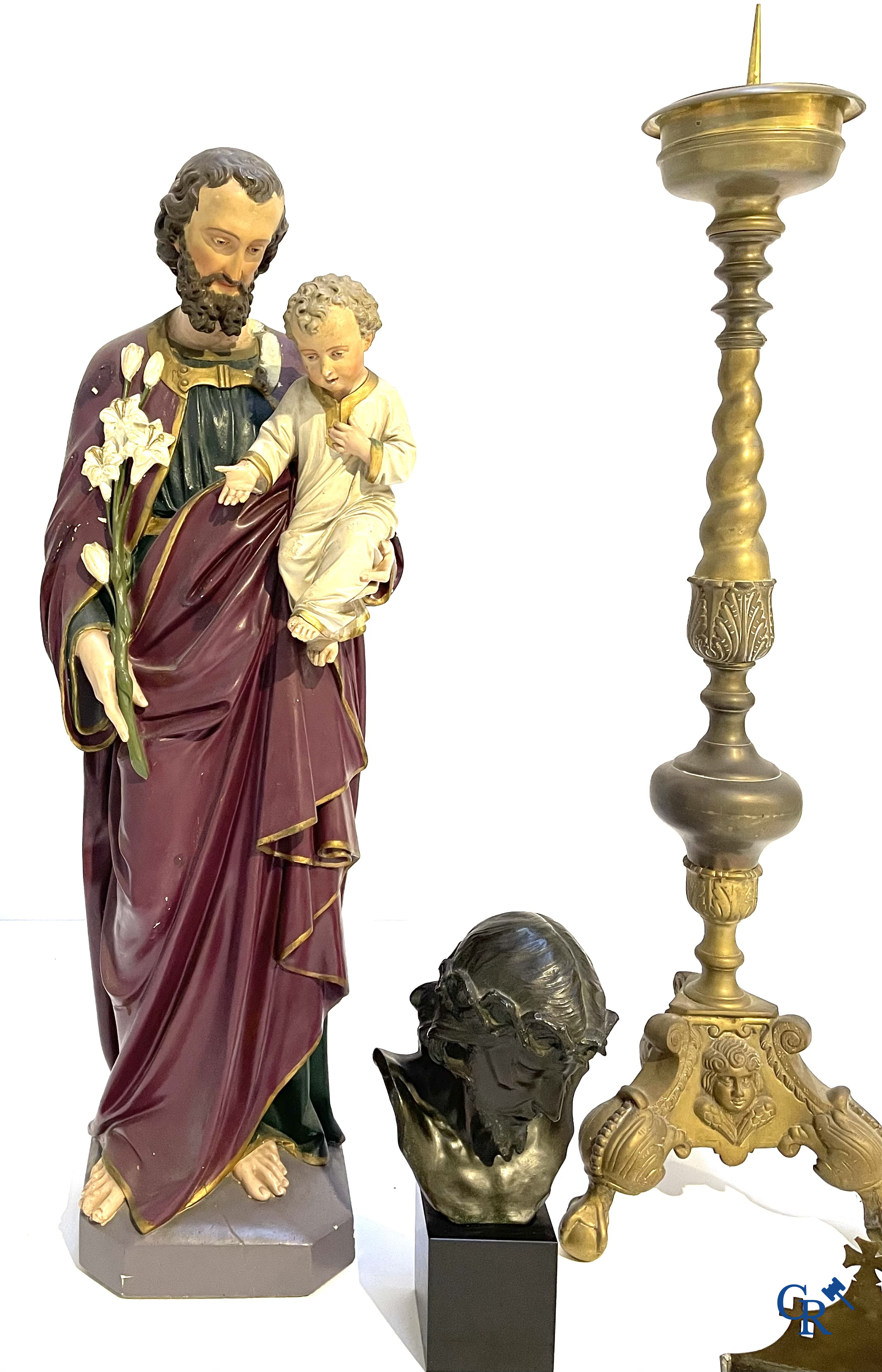 A large bronze candlestick, Saint Joseph with child in plaster, a terracotta bust of Christ and a holy water vessel.