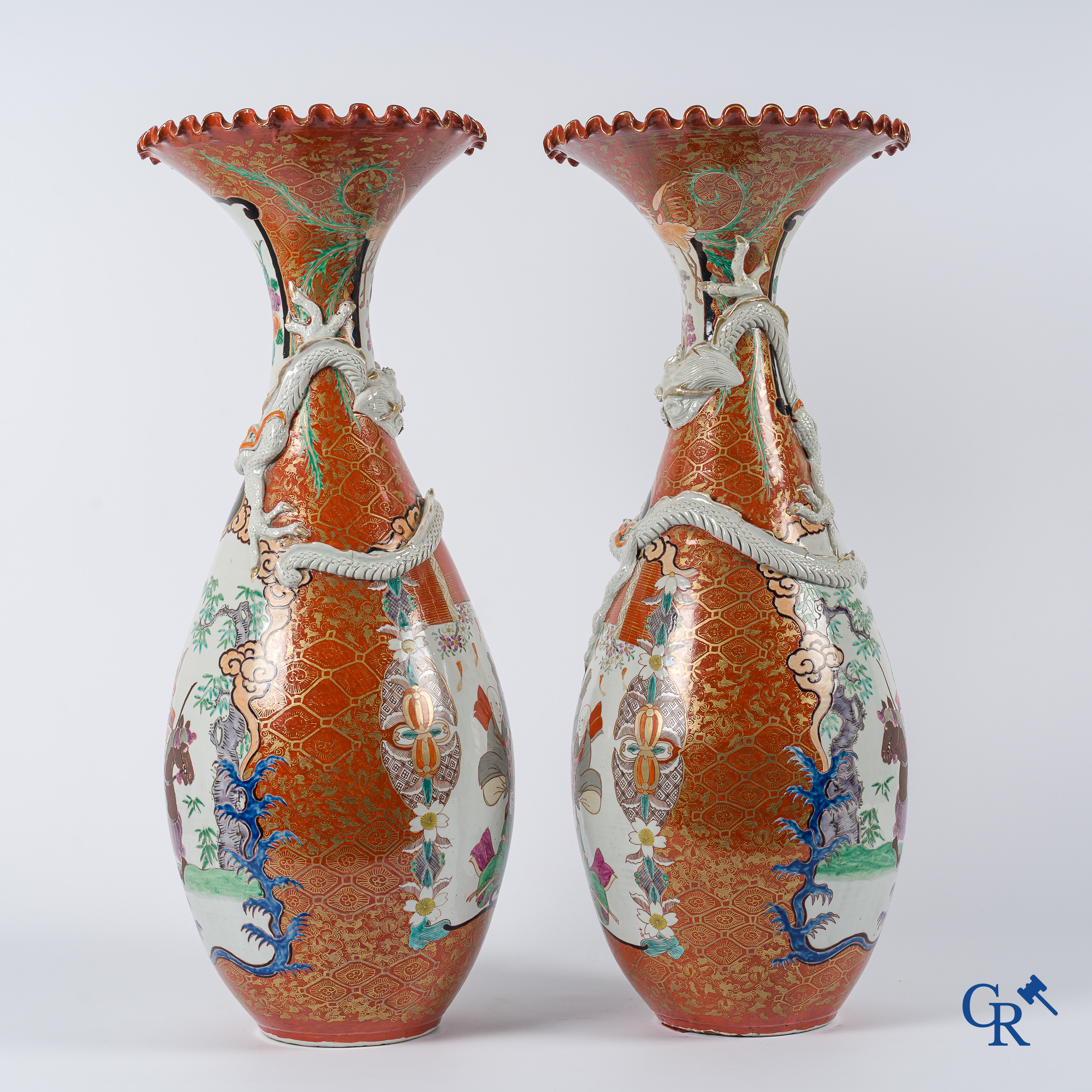 Asian Art. Japanese porcelain. Pair of large Japanese vases with scenes on a red and gilded background. 19th century.