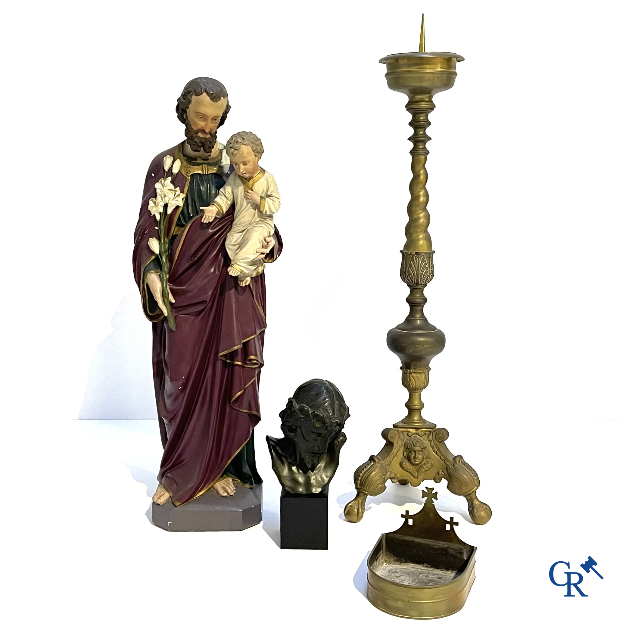 A large bronze candlestick, Saint Joseph with child in plaster, a terracotta bust of Christ and a holy water vessel.