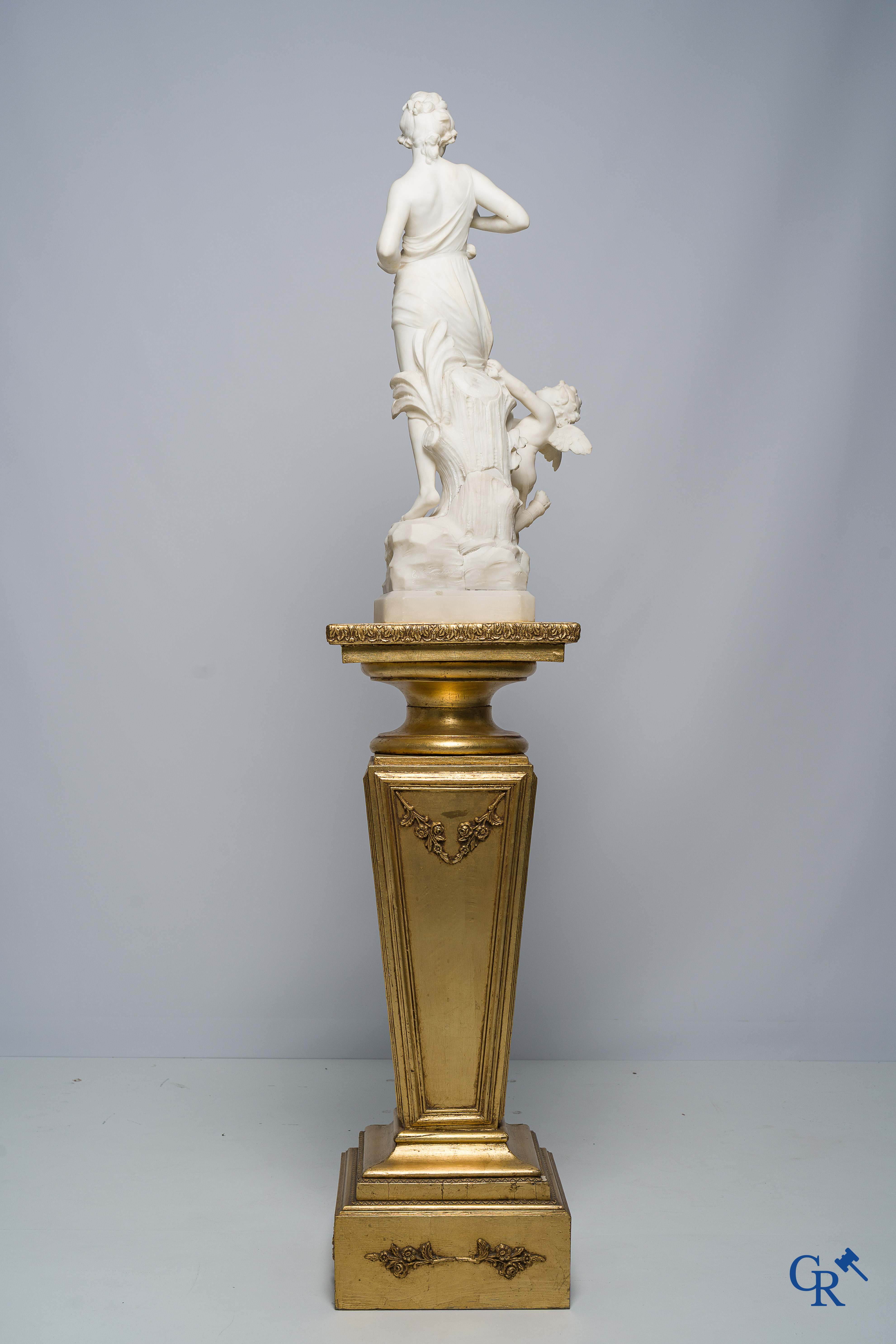 Cipriani. Romantic representation in sculpted marble. Young lady with cupid. LXVI style pedestal. Circa 1900.