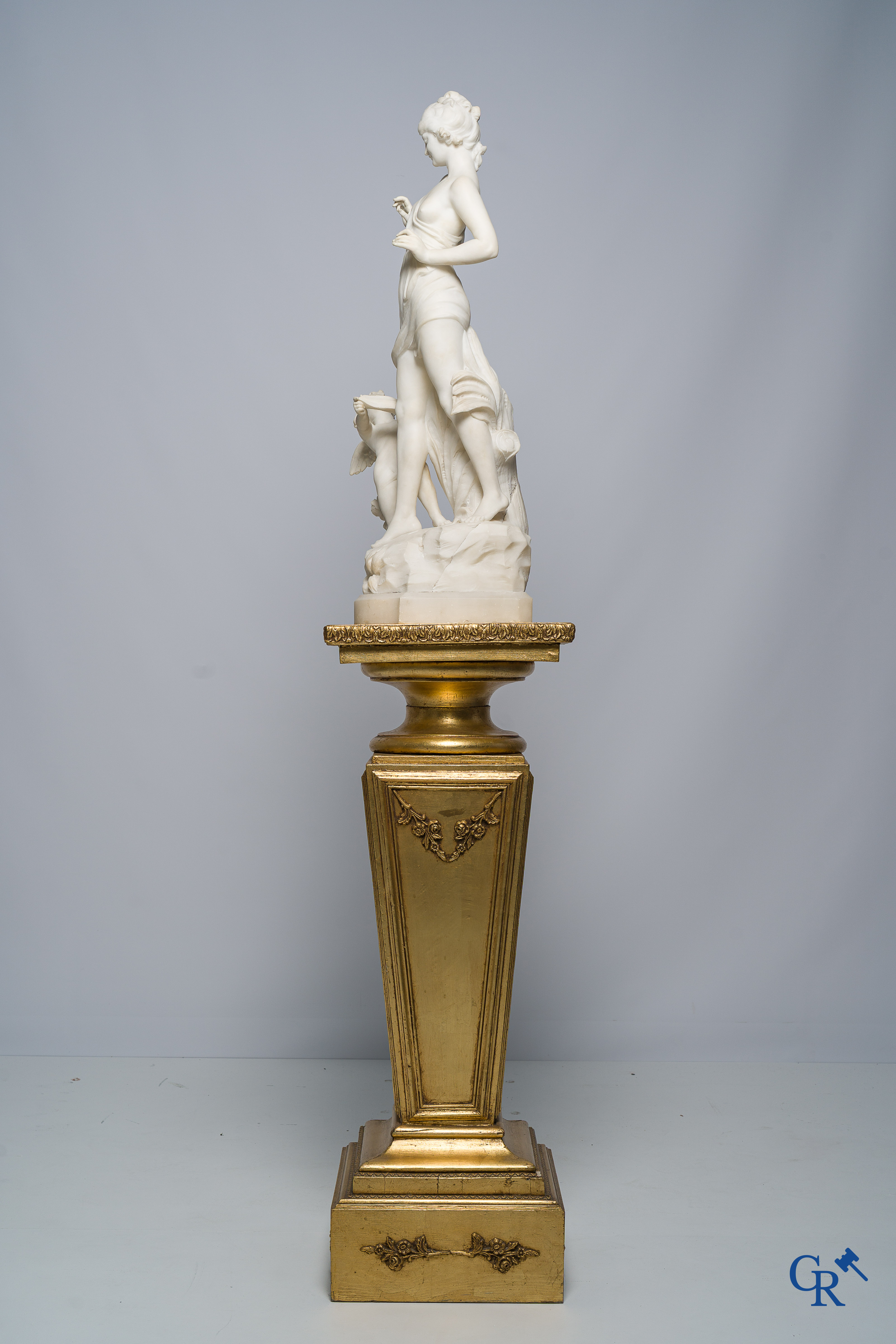 Cipriani. Romantic representation in sculpted marble. Young lady with cupid. LXVI style pedestal. Circa 1900.