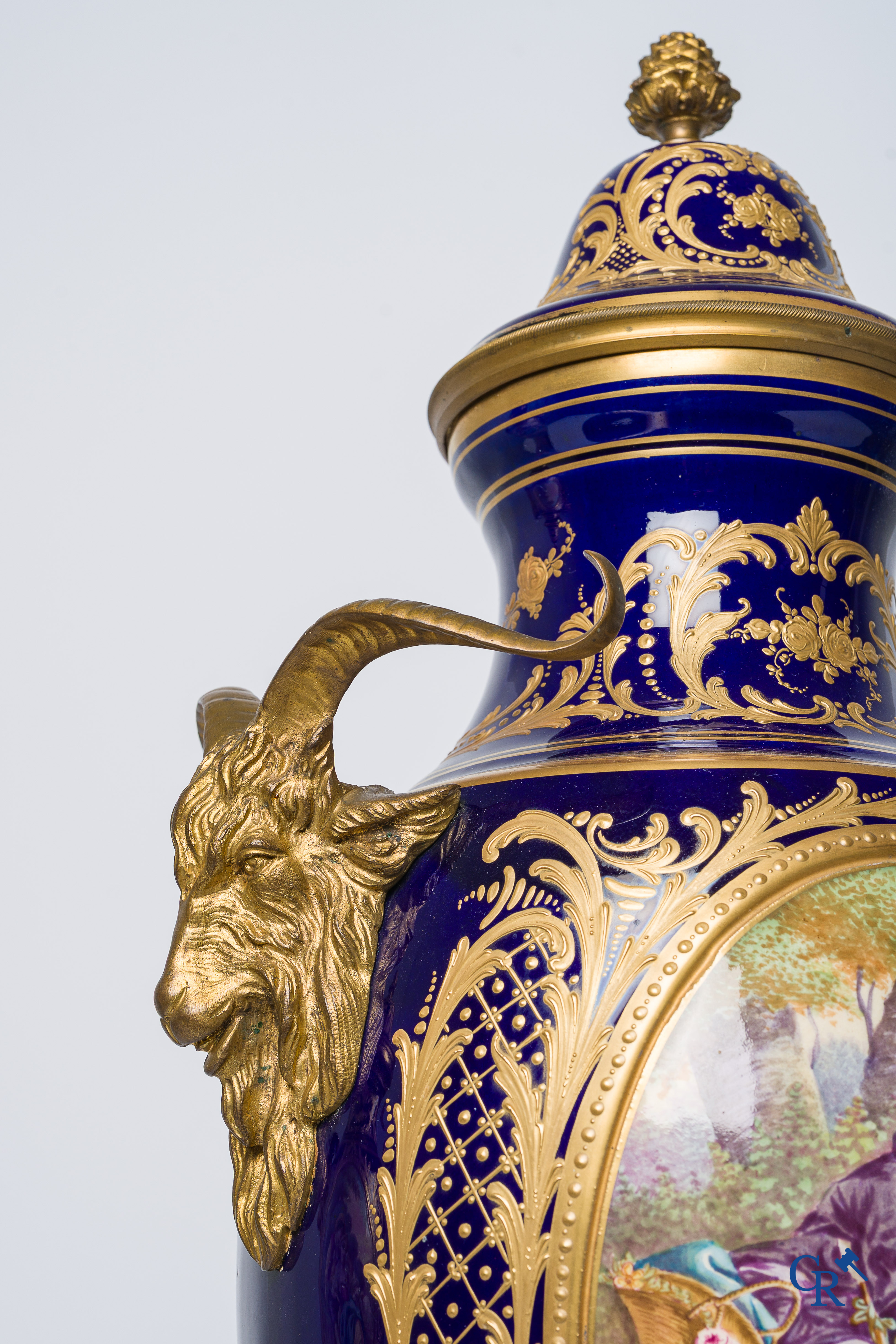 Sèvres. Pair of large decorated cobalt blue vases with bronze fittings and raised gilding. LXVI style. circa 1920.