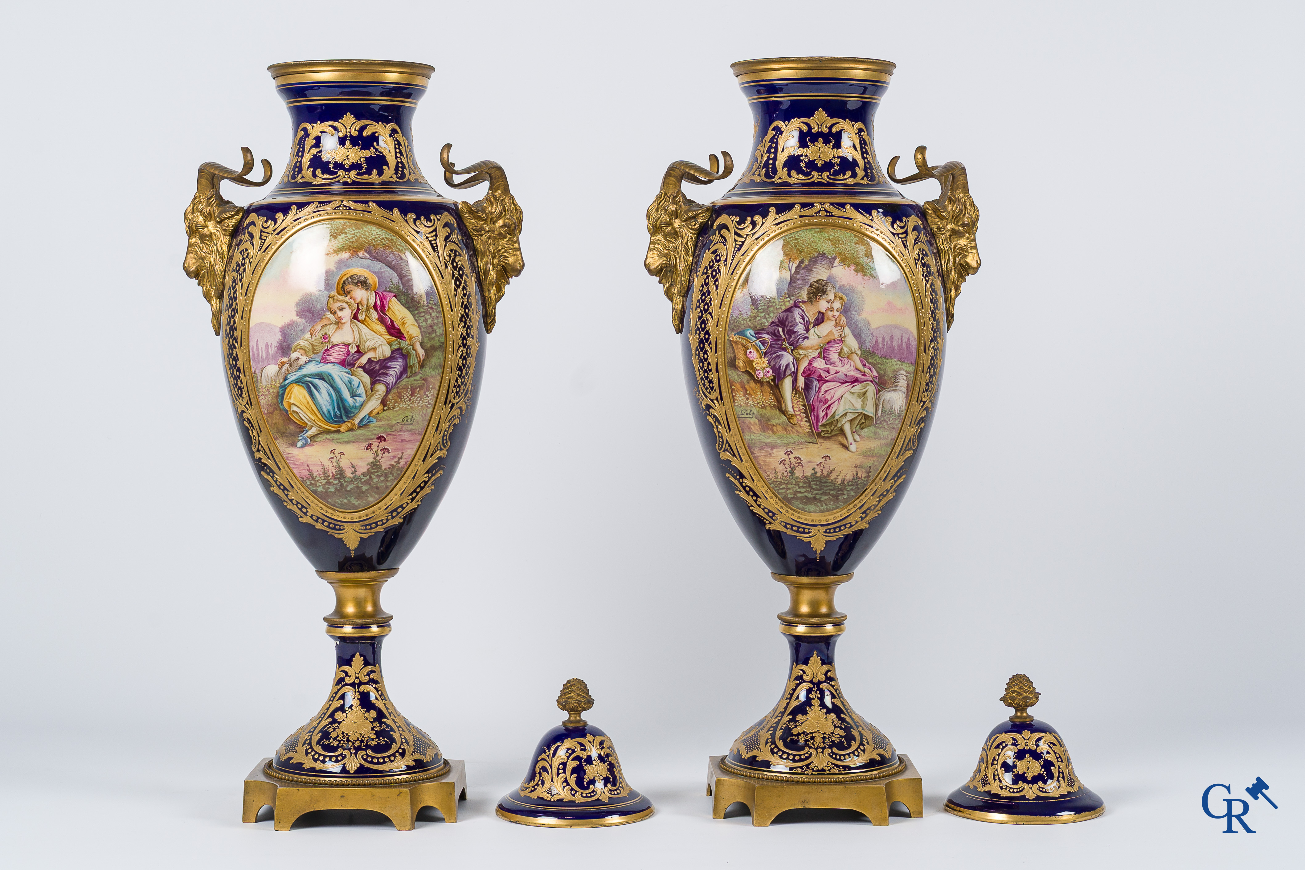 Sèvres. Pair of large decorated cobalt blue vases with bronze fittings and raised gilding. LXVI style. circa 1920.