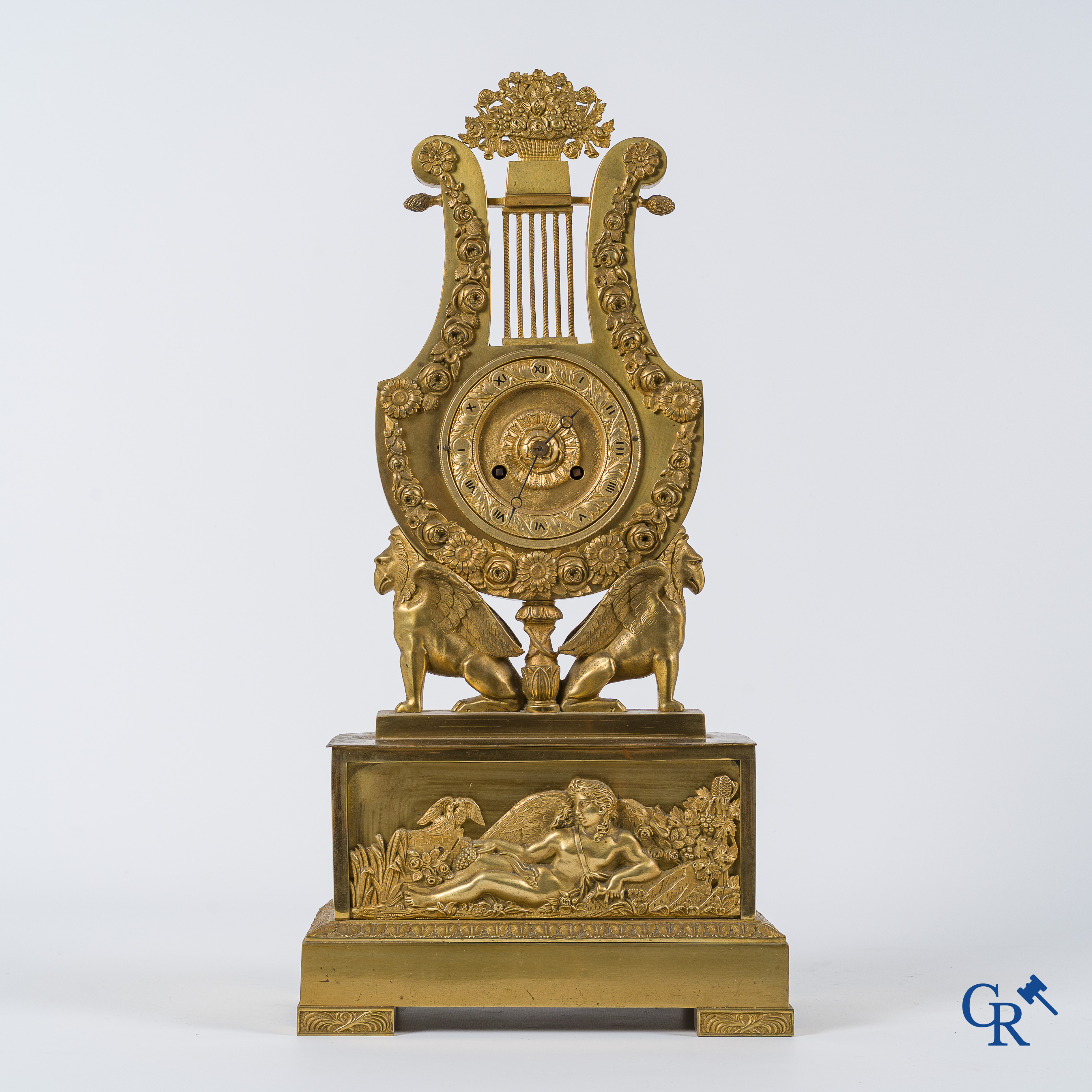Charles X period. Beautiful pendulum in gilded bronze, a lyre held up by griffins. France, circa 1825.