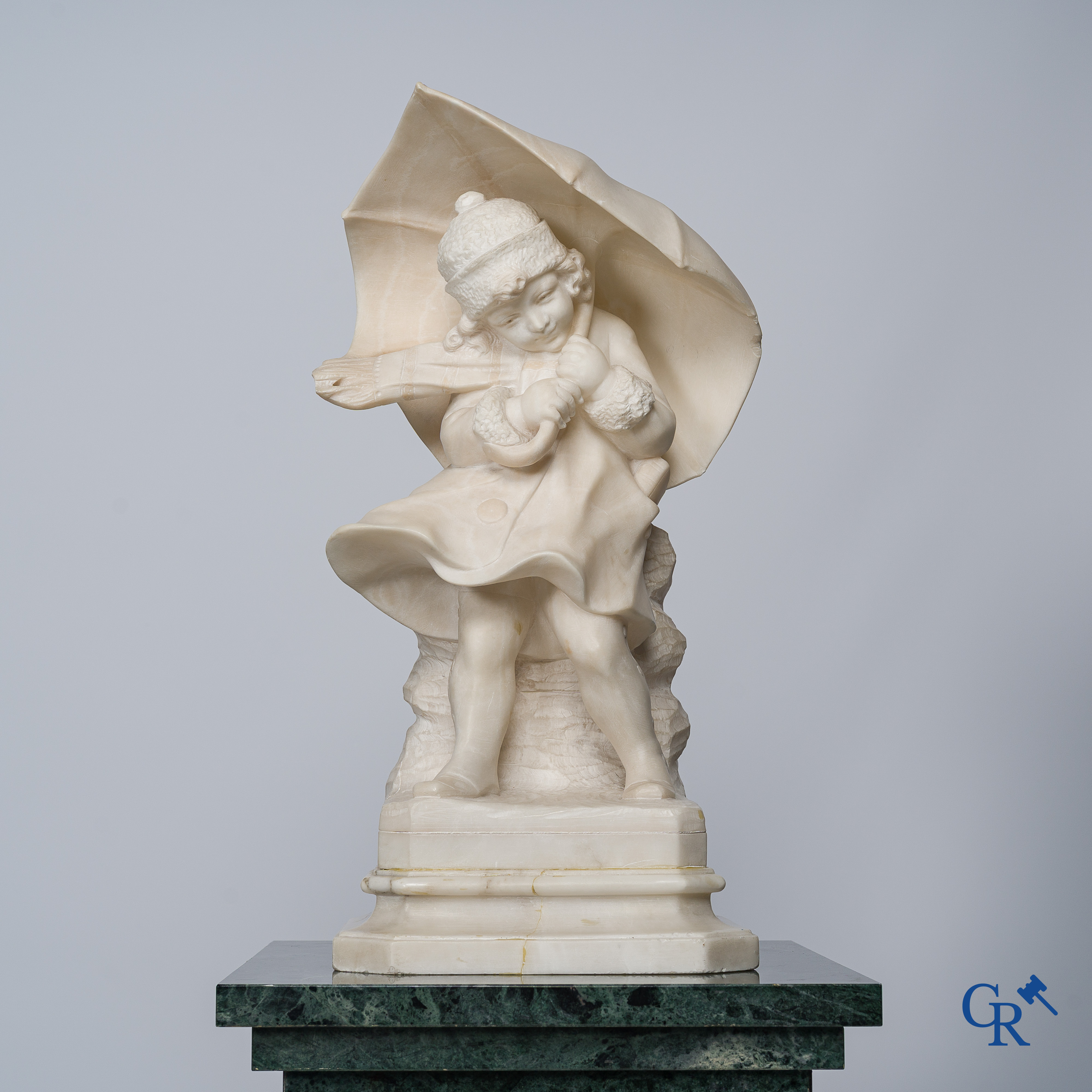 Amusing statue of a girl with umbrella in sculpted marble. No signature noticeable. Around 1920.