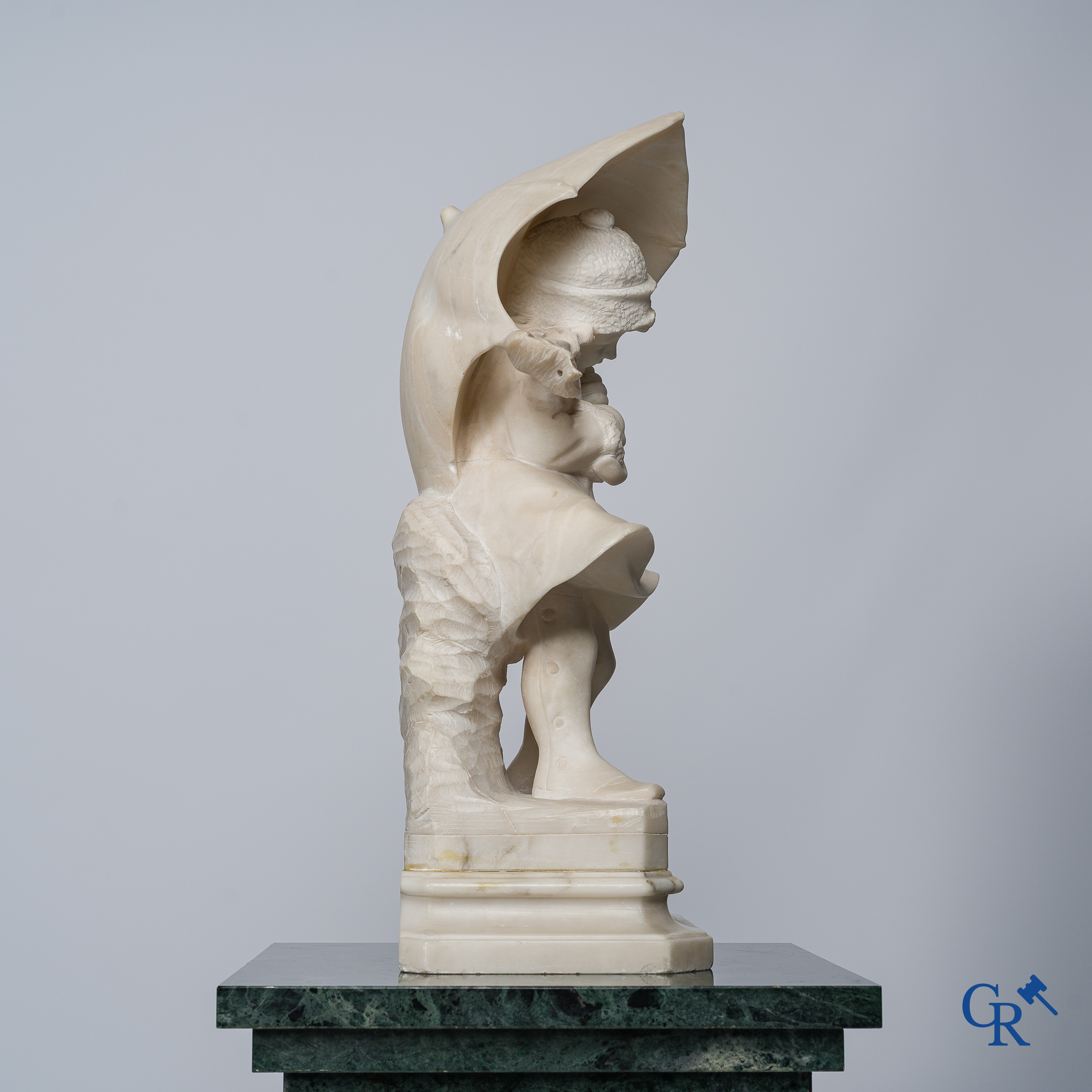 Amusing statue of a girl with umbrella in sculpted marble. No signature noticeable. Around 1920.