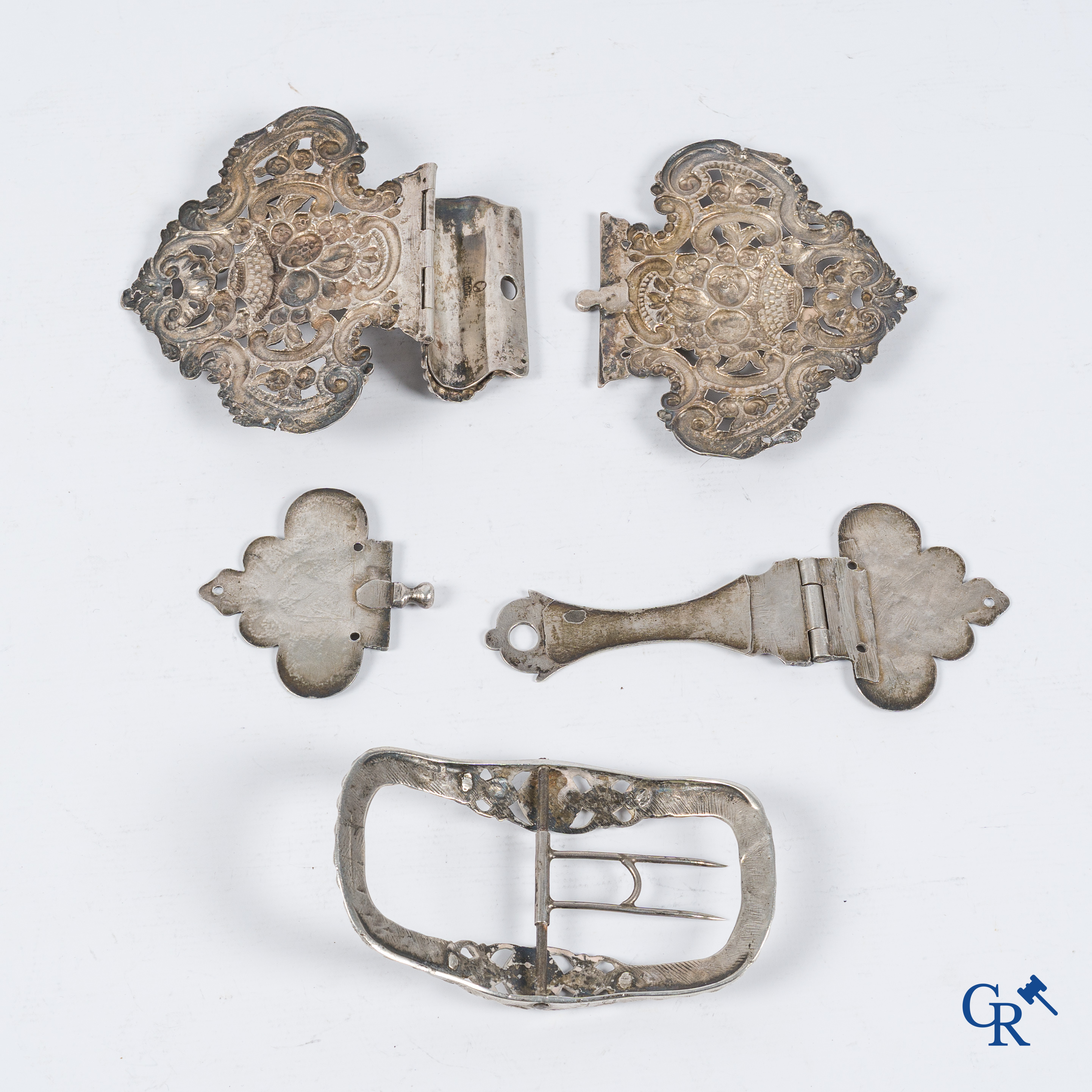 Silver. 2 book clasps and a belt buckle in worked silver. 18th-19th century.