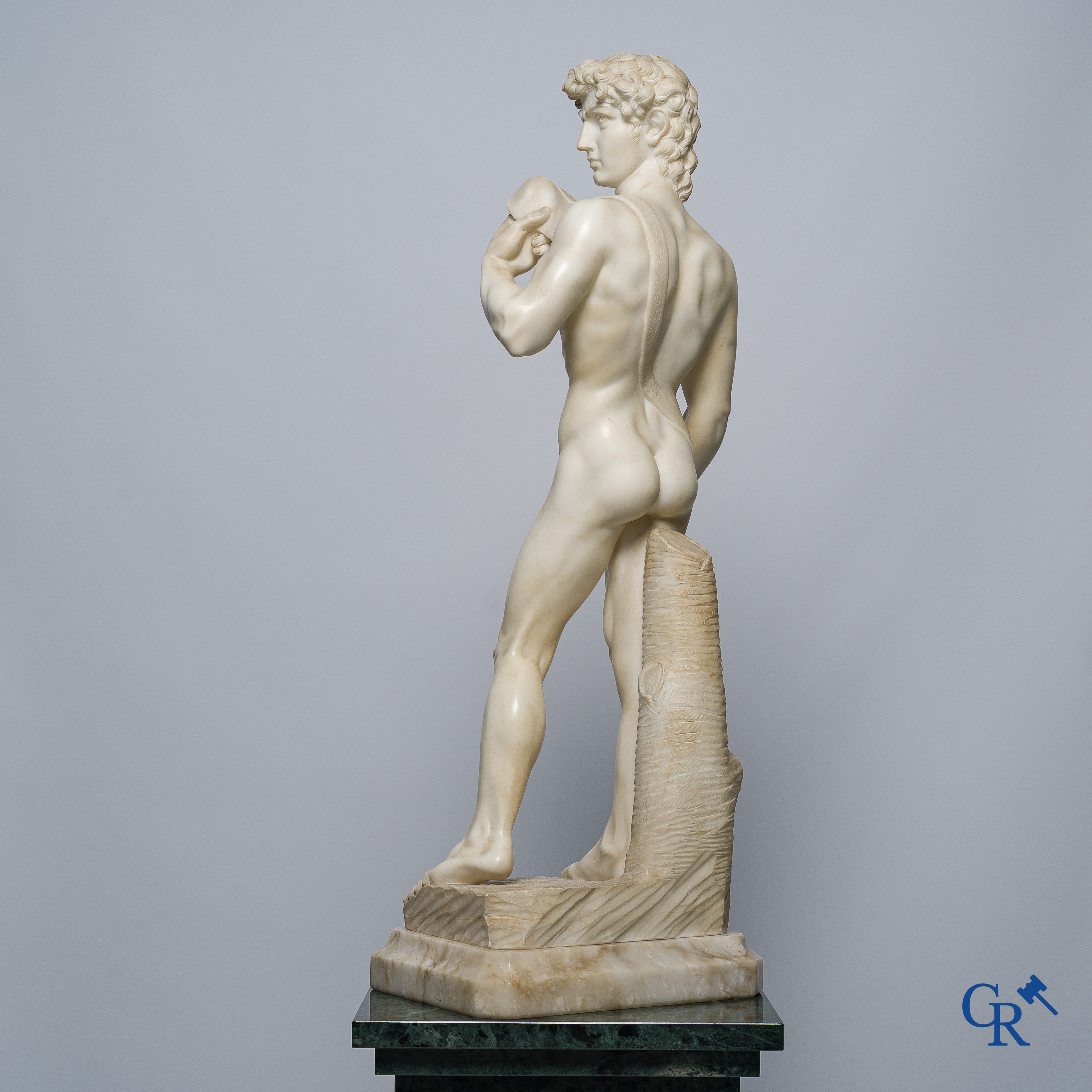 Michelangelo (after) In the antique style. Representation of David in sculpted marble. Mid-20th century.