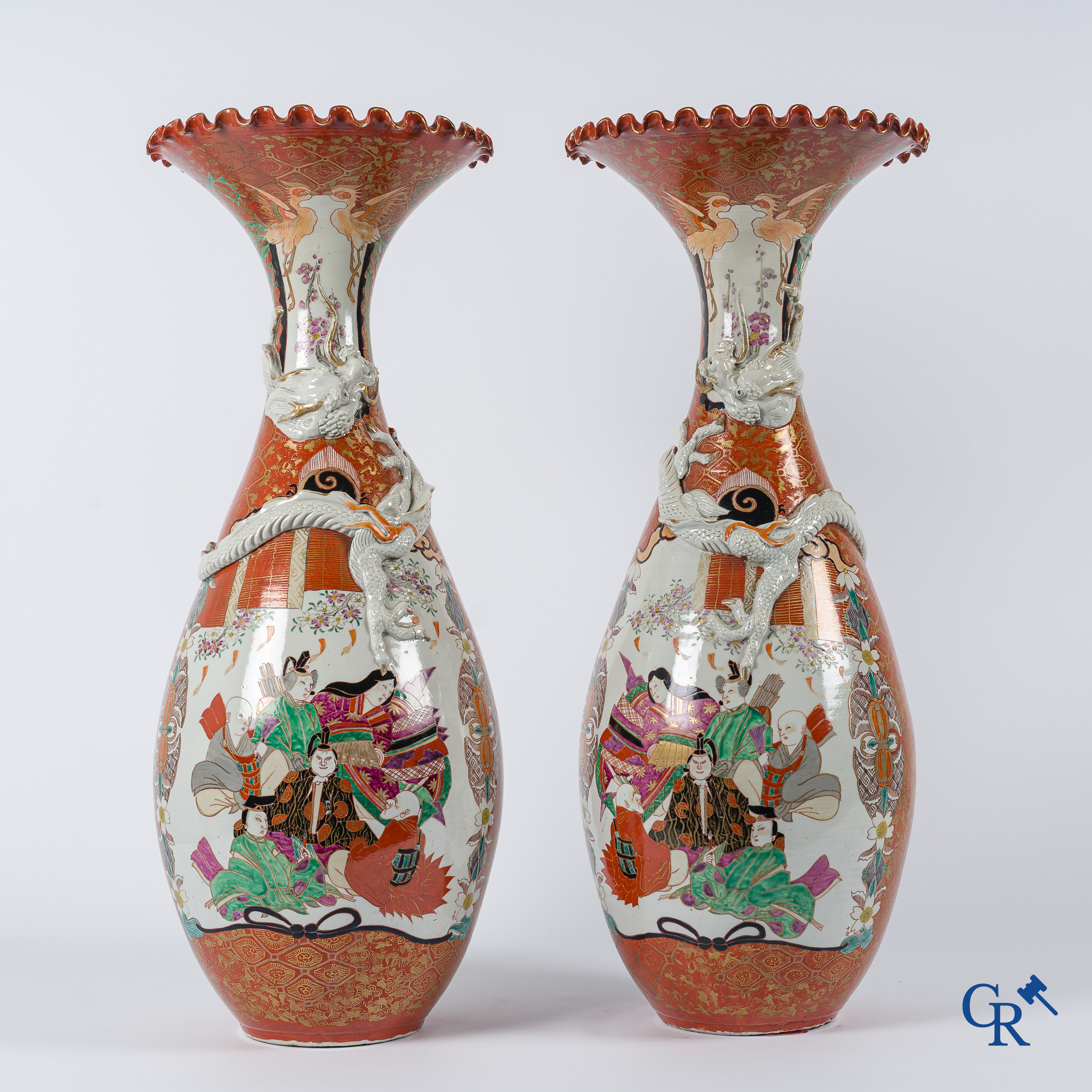 Asian Art. Japanese porcelain. Pair of large Japanese vases with scenes on a red and gilded background. 19th century.