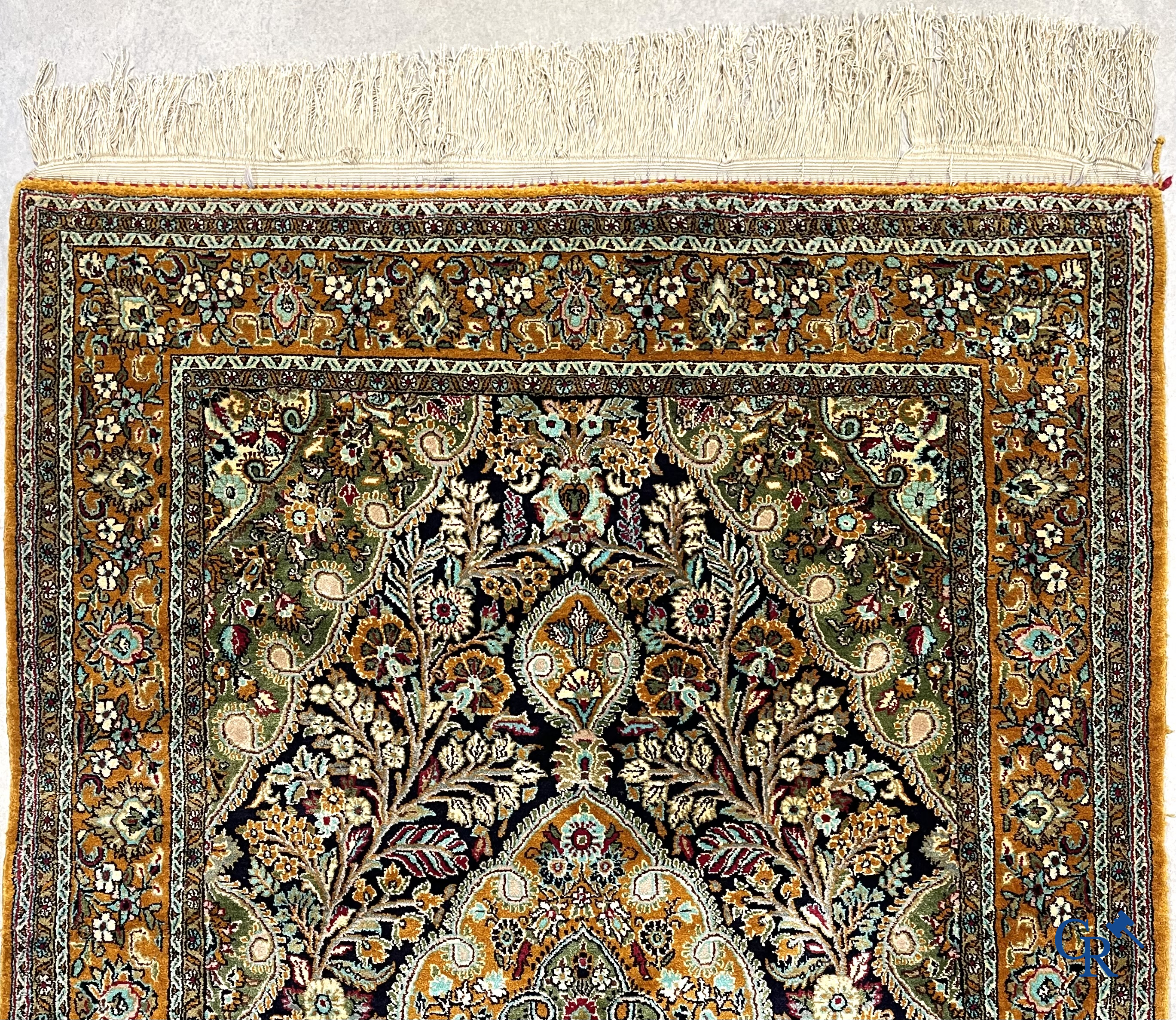 Tapis d'orient. Tapis en soie noué à la main avec un décor floral sur fond orange.