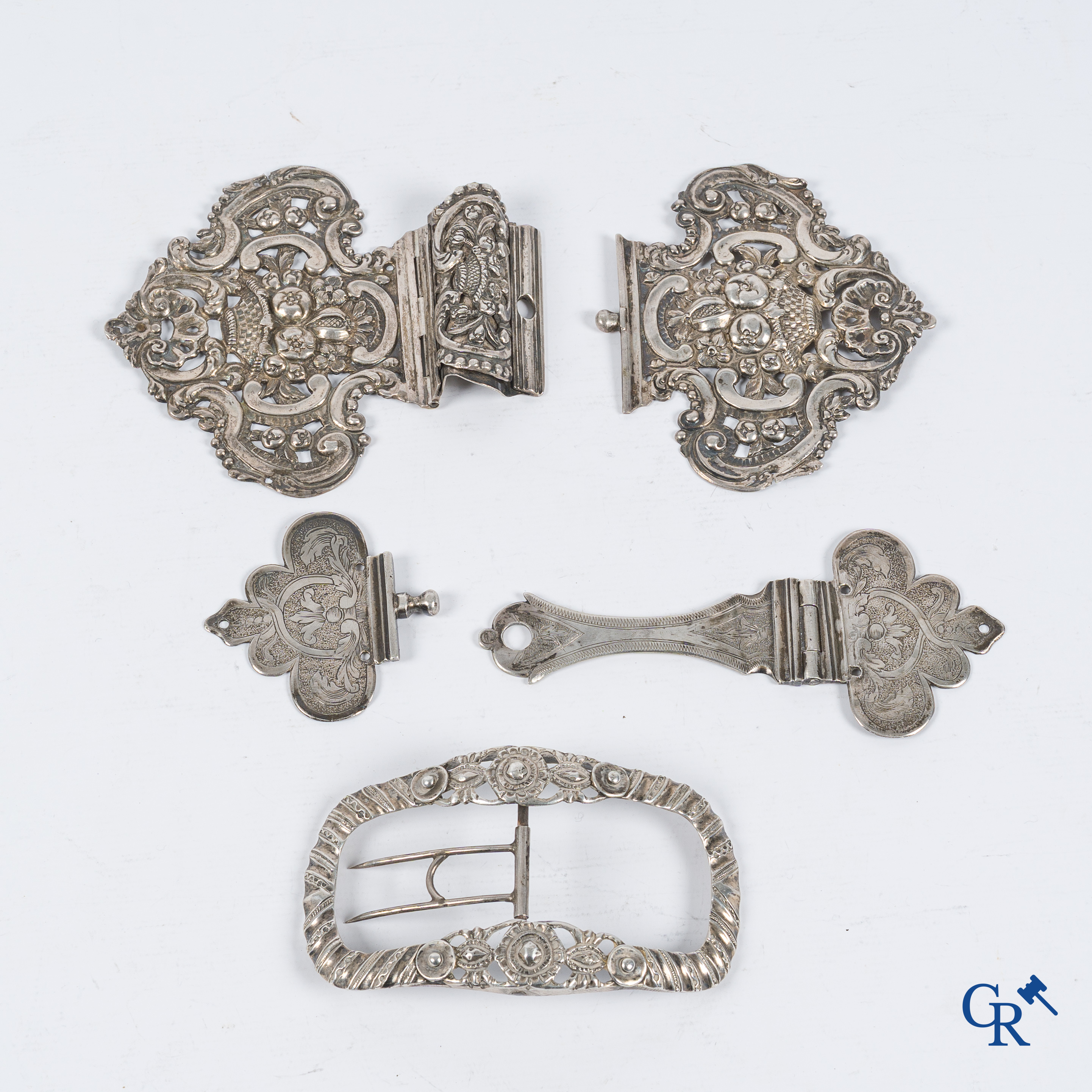 Silver. 2 book clasps and a belt buckle in worked silver. 18th-19th century.