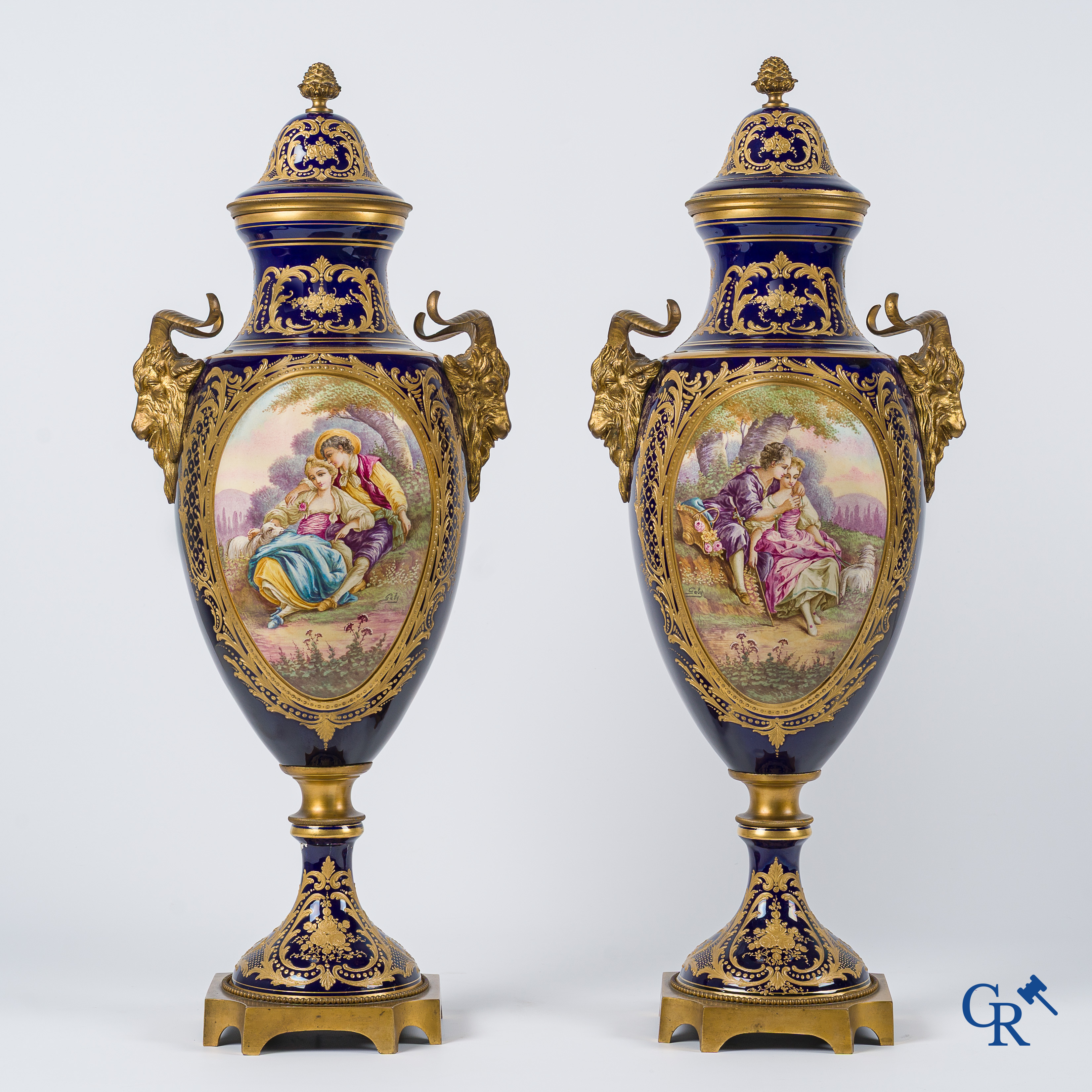 Sèvres. Pair of large decorated cobalt blue vases with bronze fittings and raised gilding. LXVI style. circa 1920.