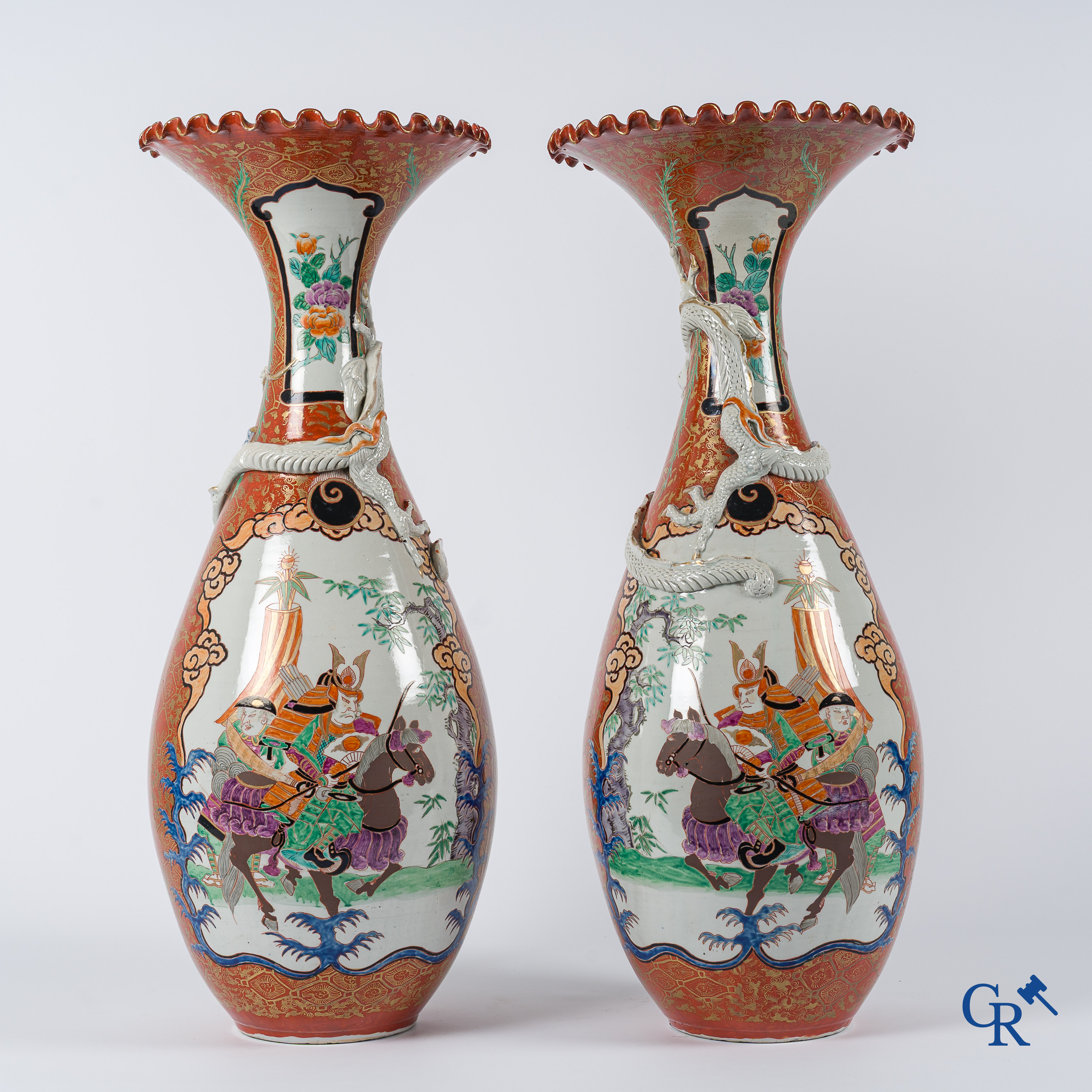 Asian Art. Japanese porcelain. Pair of large Japanese vases with scenes on a red and gilded background. 19th century.