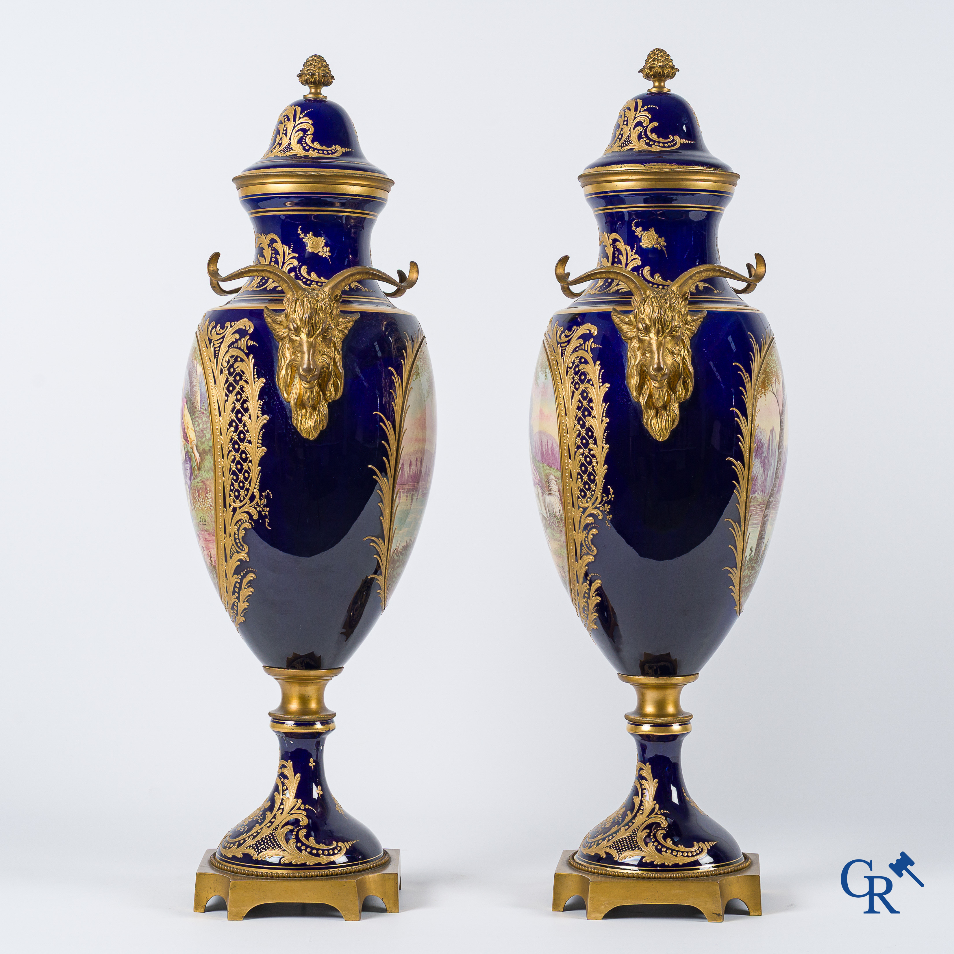 Sèvres. Pair of large decorated cobalt blue vases with bronze fittings and raised gilding. LXVI style. circa 1920.
