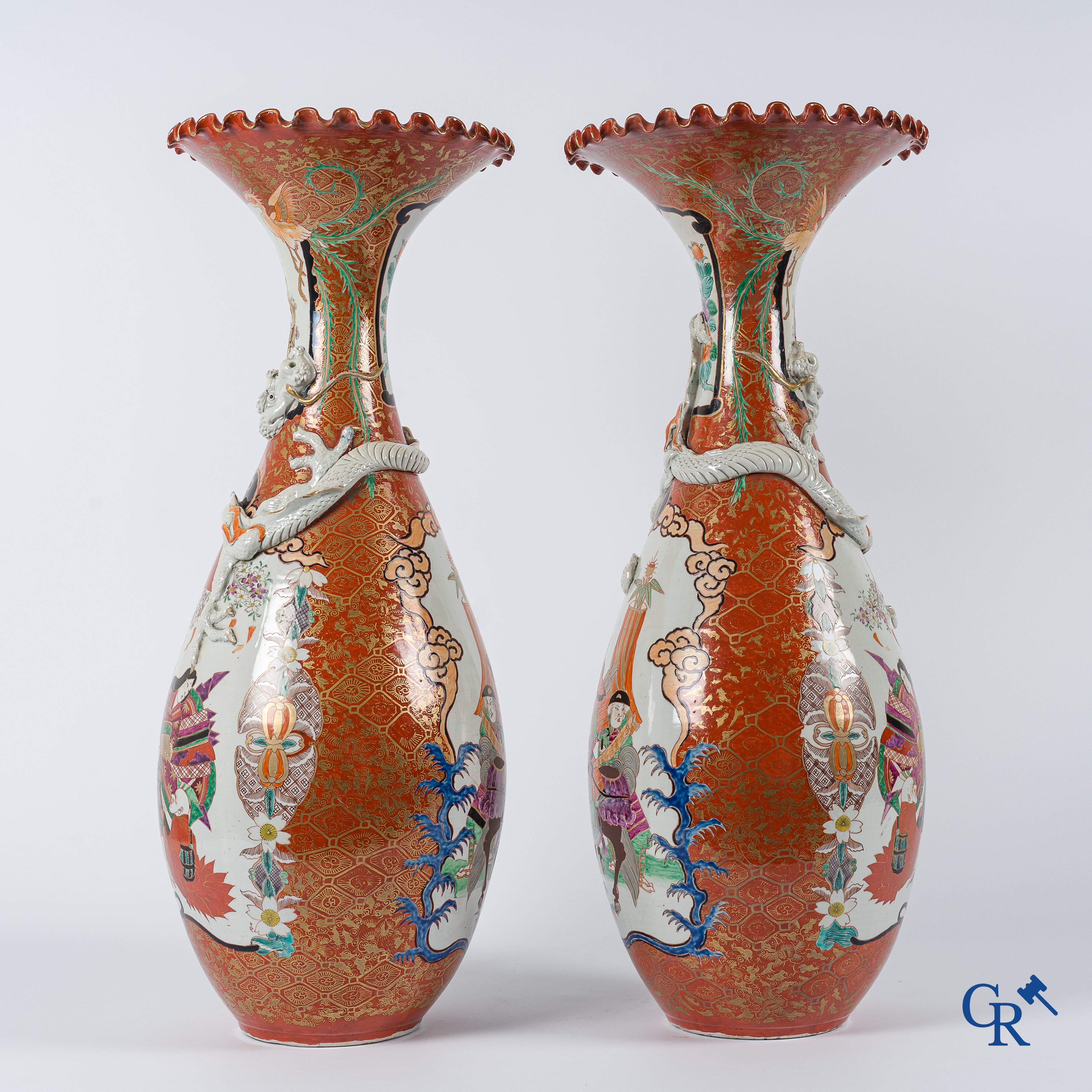 Asian Art. Japanese porcelain. Pair of large Japanese vases with scenes on a red and gilded background. 19th century.