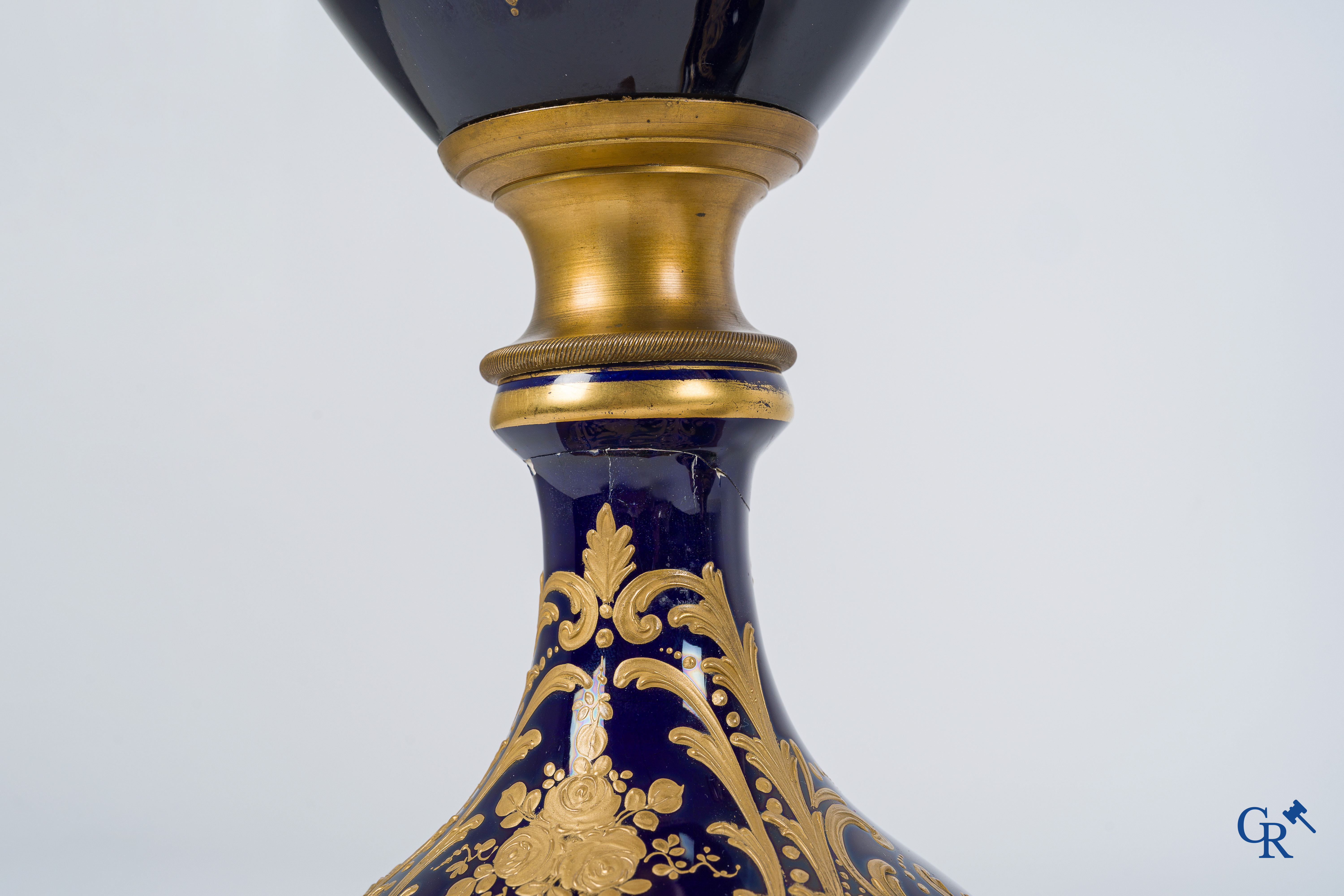 Sèvres. Pair of large decorated cobalt blue vases with bronze fittings and raised gilding. LXVI style. circa 1920.