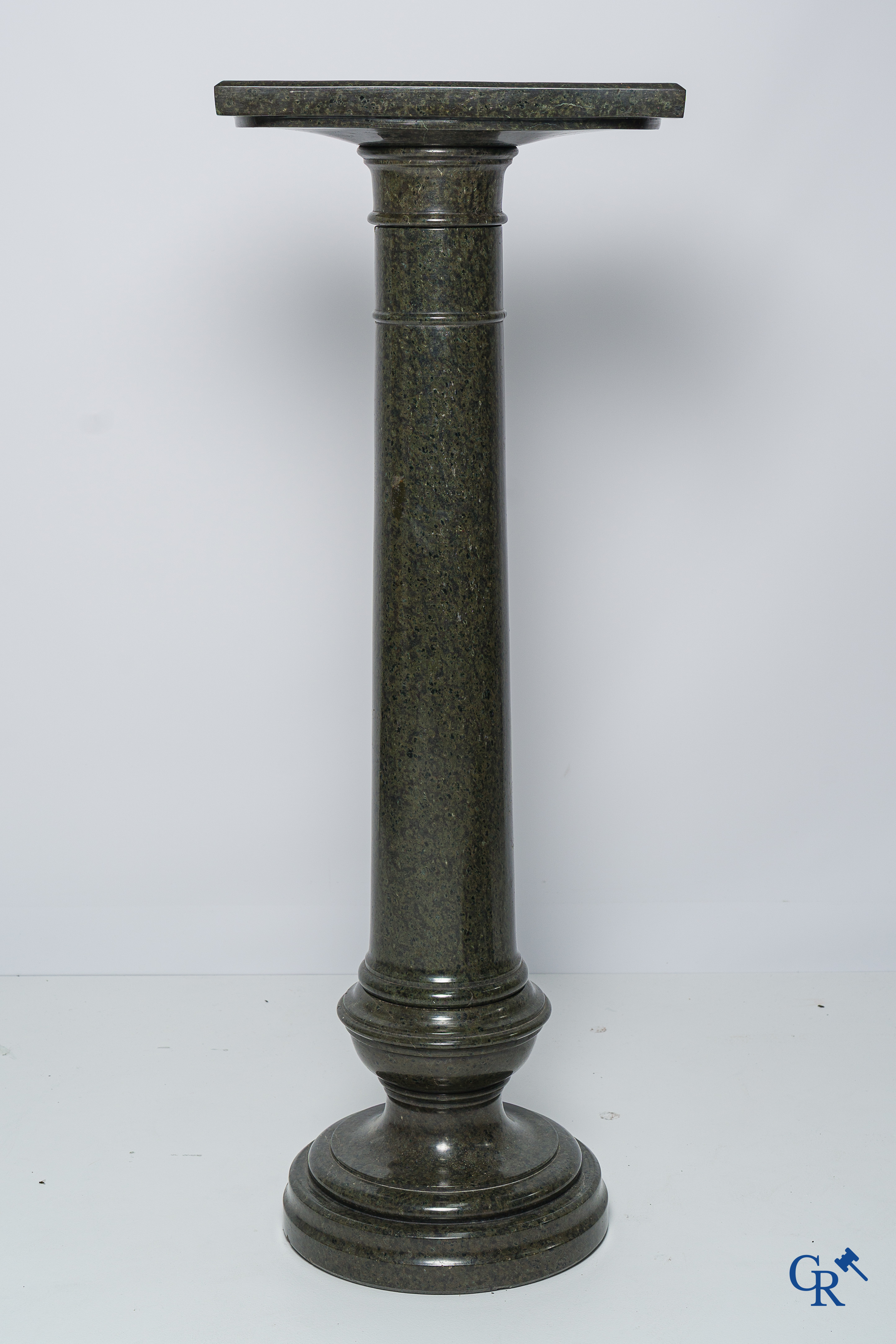 Art Nouveau. Marble statue of a sitting young lady on a chair. Associated pedestal in serpentine. Circa 1910.