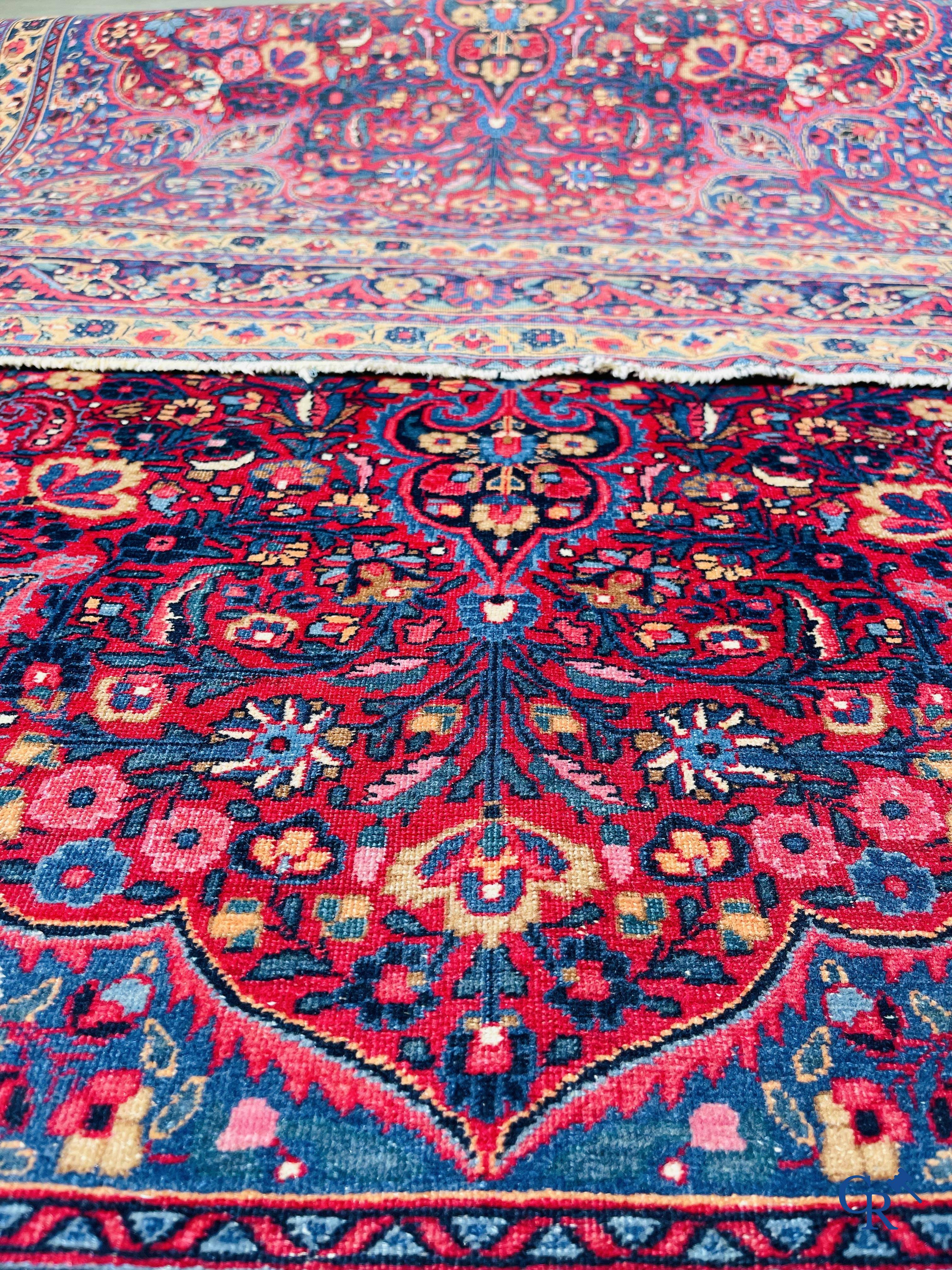 Oriental carpets: Iran, antique Persian carpet with dark red background.