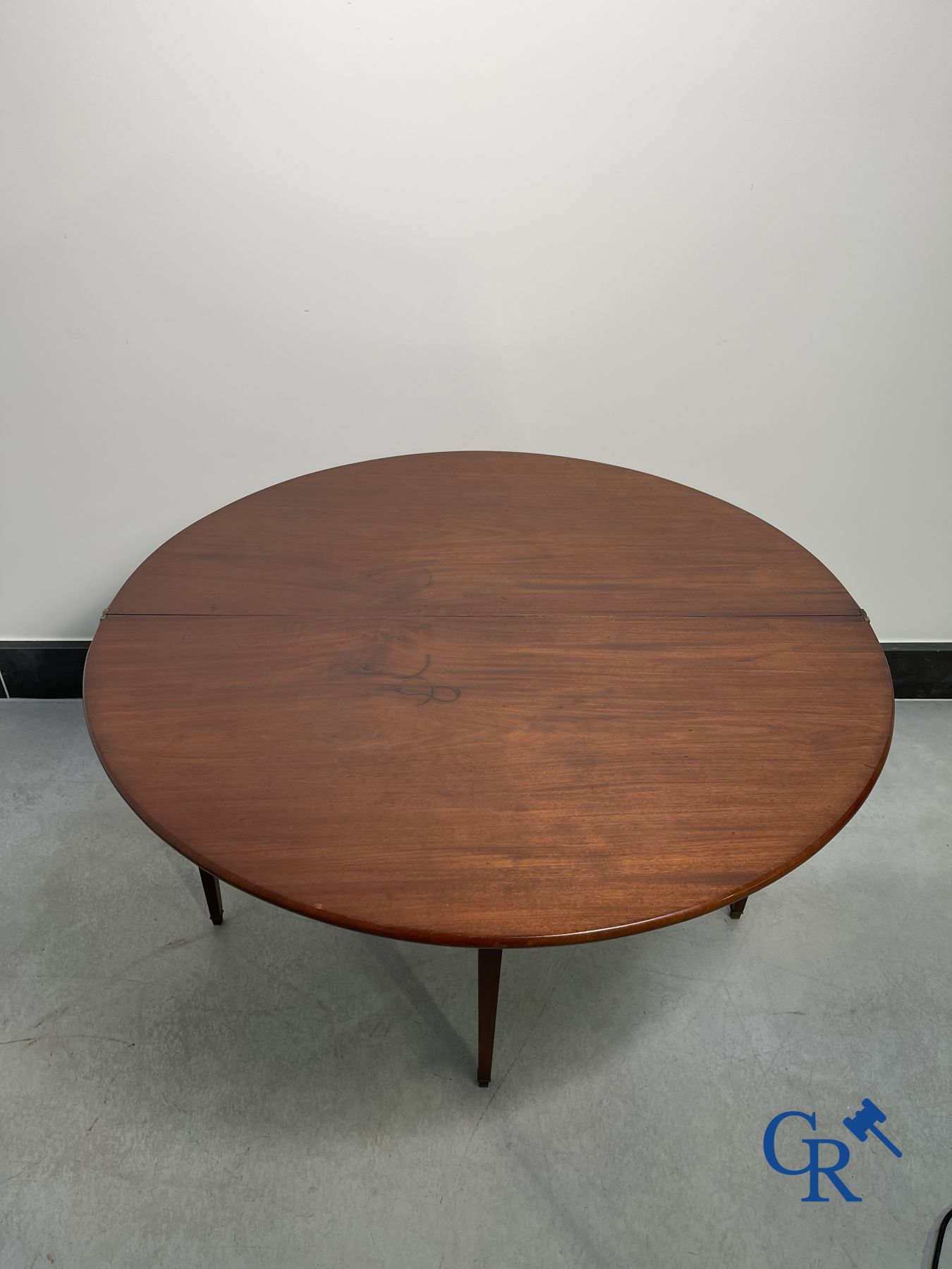 Furniture: fold-out crescent-shaped mahogany table. Directoire period.