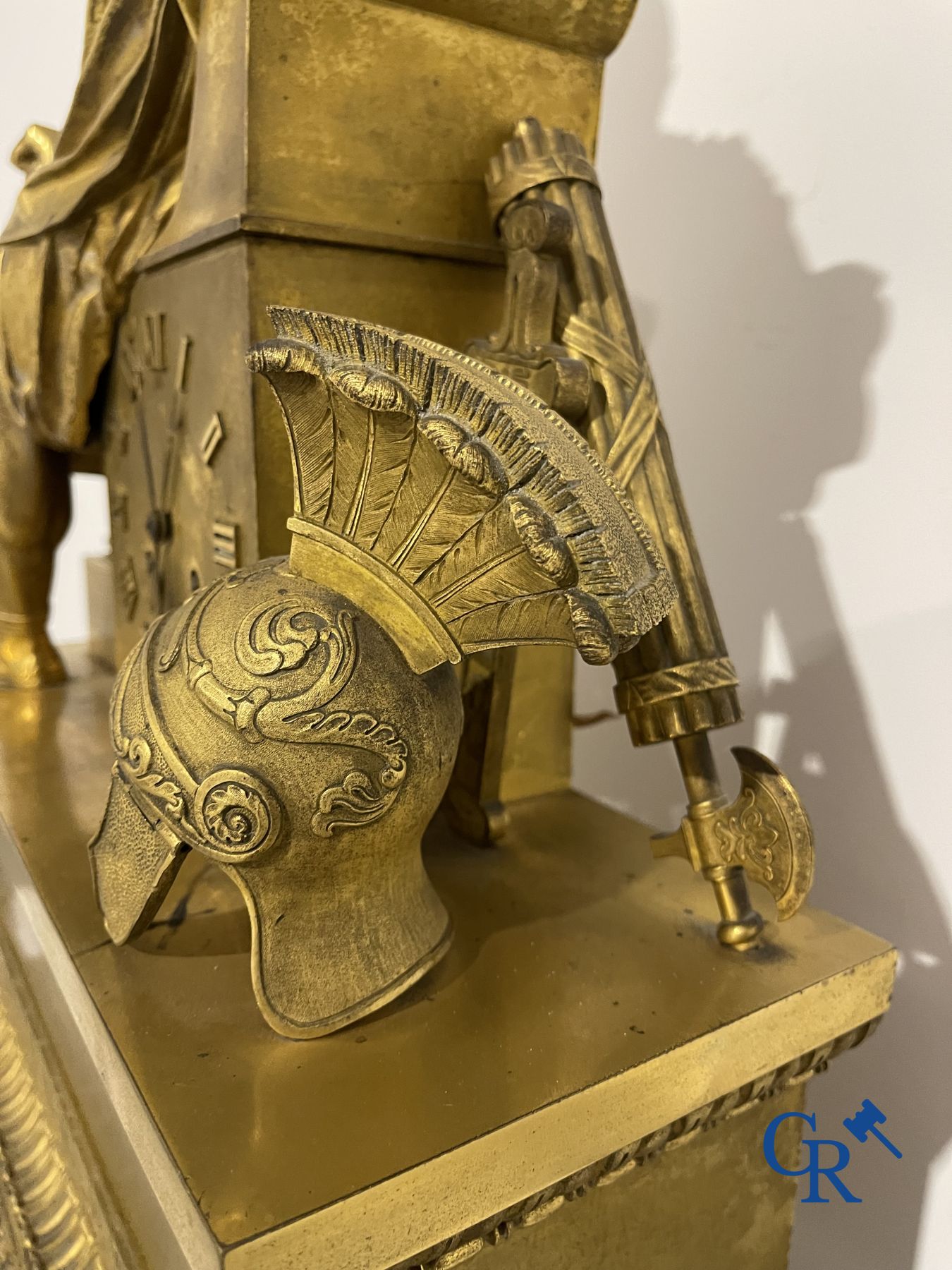 Imposing fire-gilded empire pendulum depicting a seated Roman emperor.