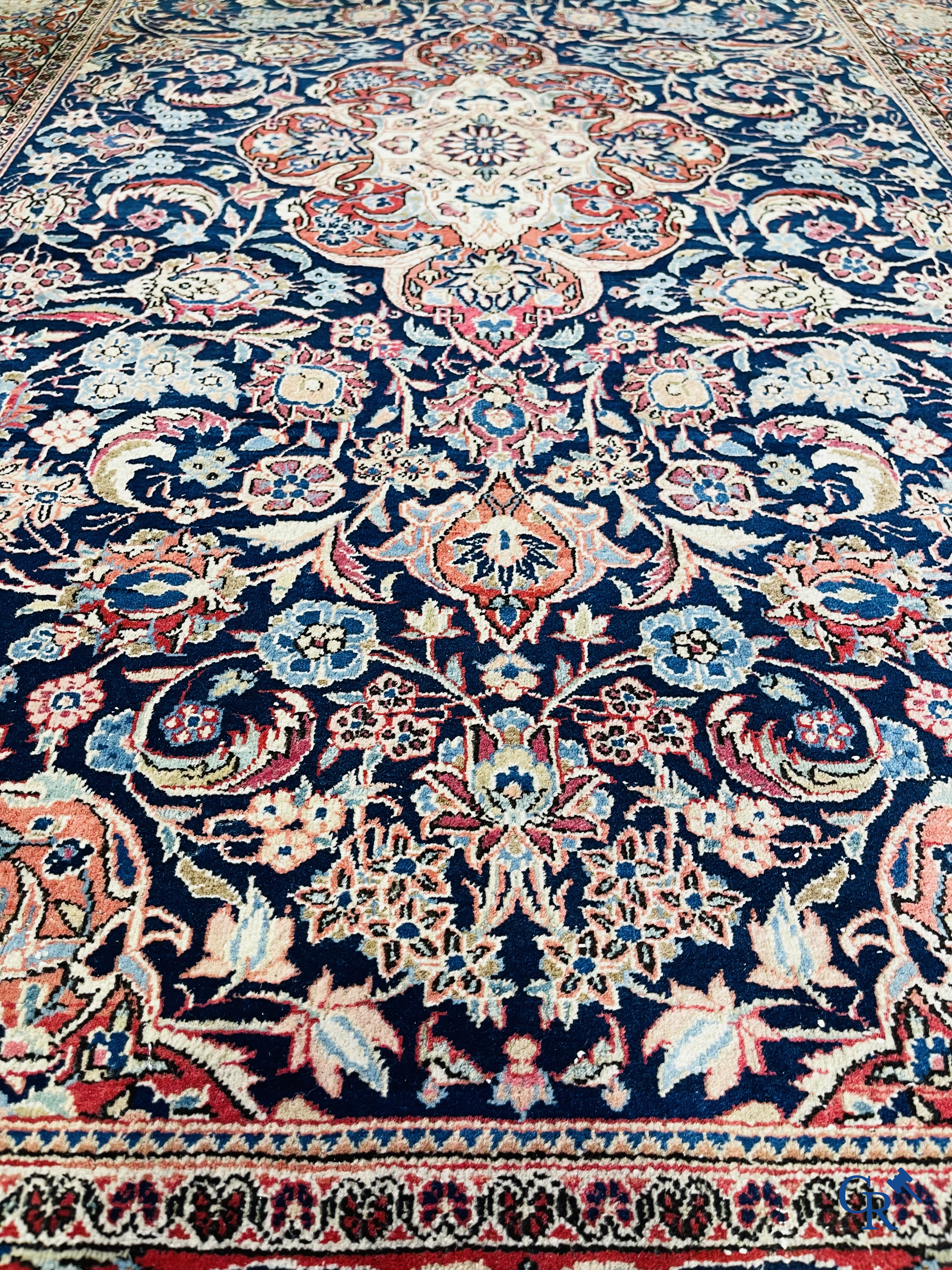 Oriental carpets: Iran. 2 antique hand-knotted Persian carpets with floral decor.