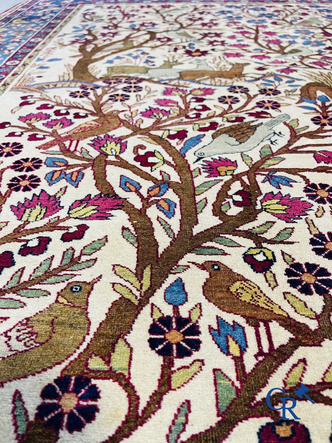 Oriental carpets: Antique oriental carpet with a decor of animals and birds in the forest.