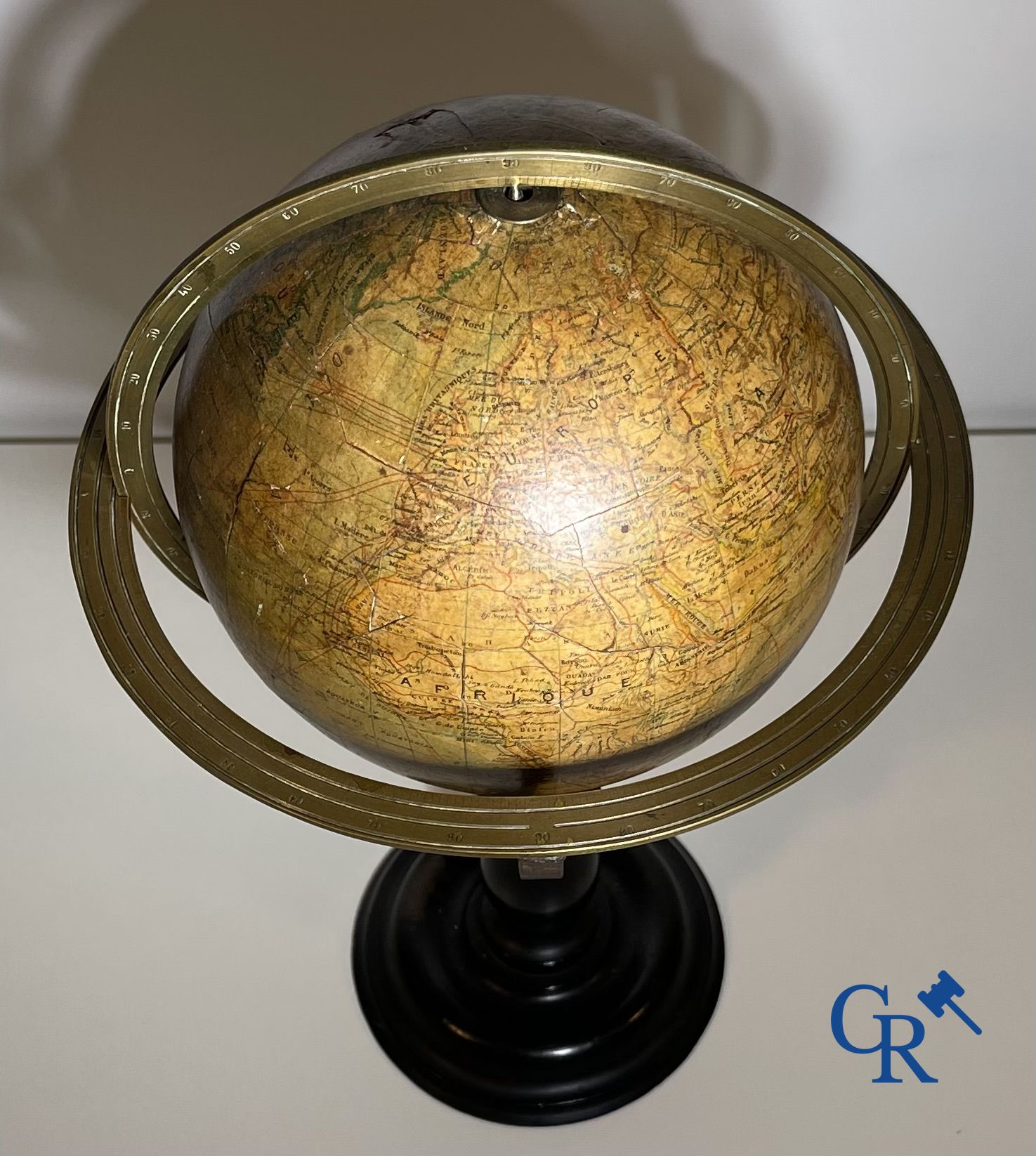 An antique globe with meridian circle on a black lacquered wooden base. 19th century.