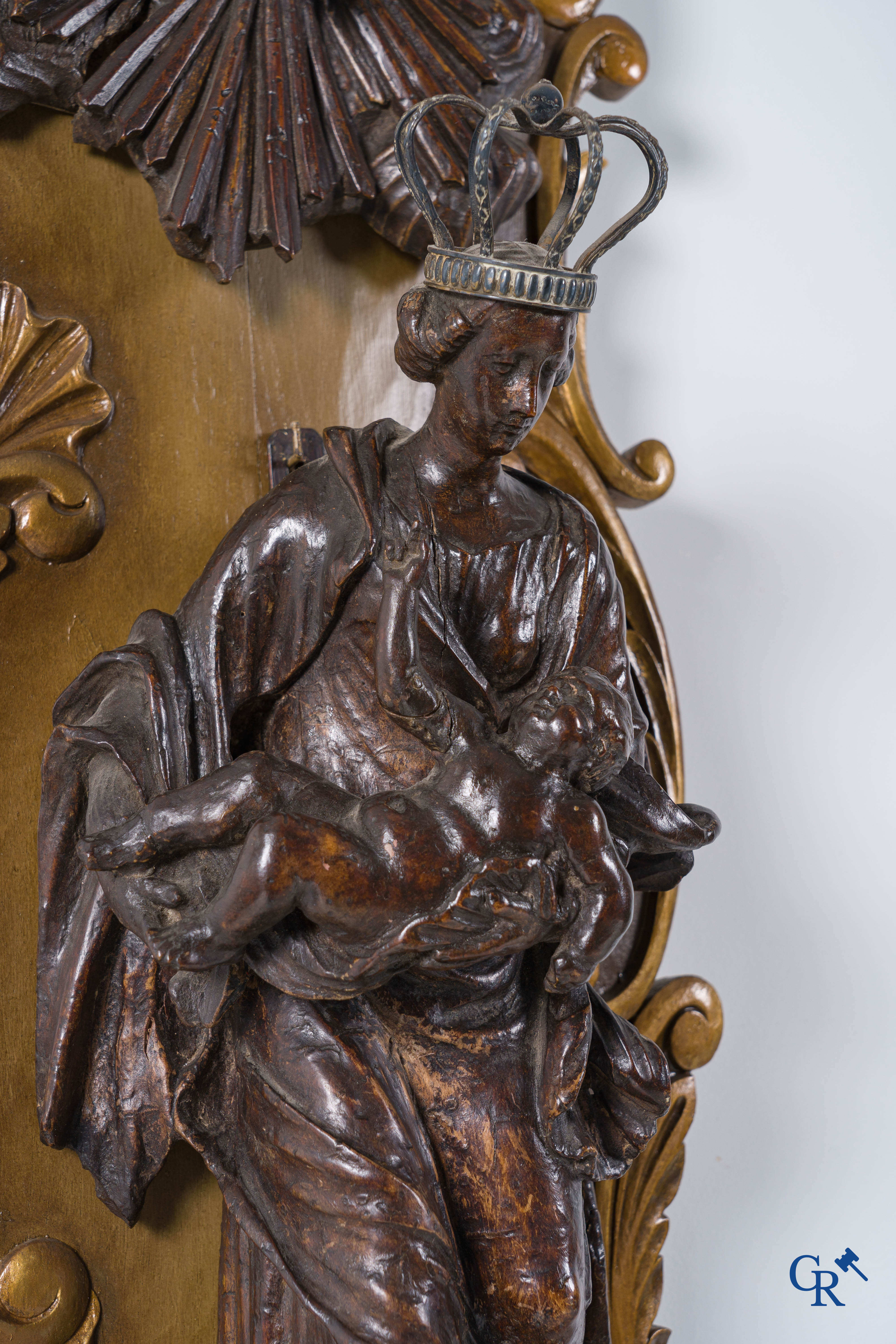 Imposing wooden sculpture of Mary with child, richly sculpted with angels and a dragon. 17th-18th century.