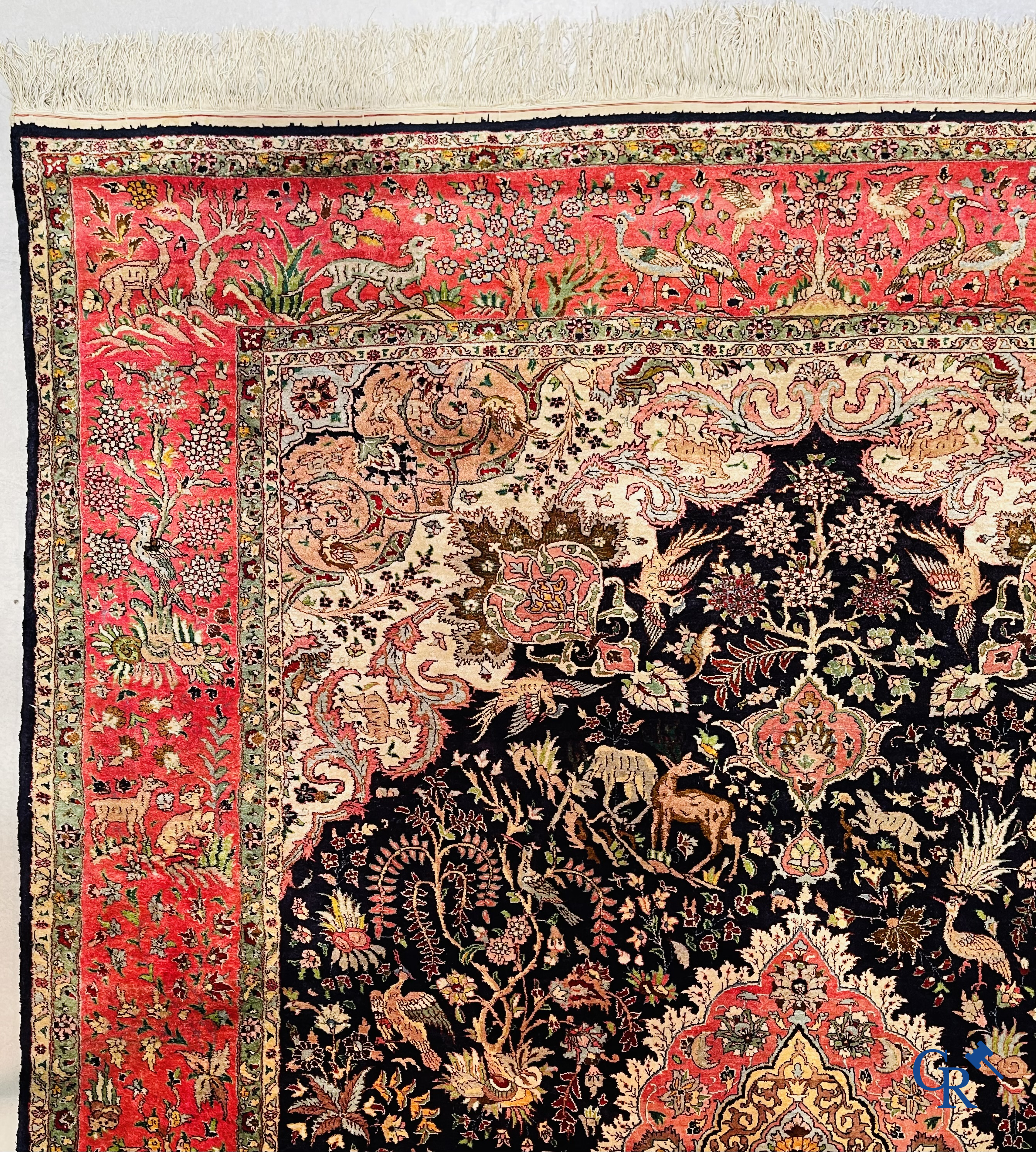 Oriental carpets: Tabriz, a finely hand-knotted silk carpet with forest animals and birds in a floral decor.