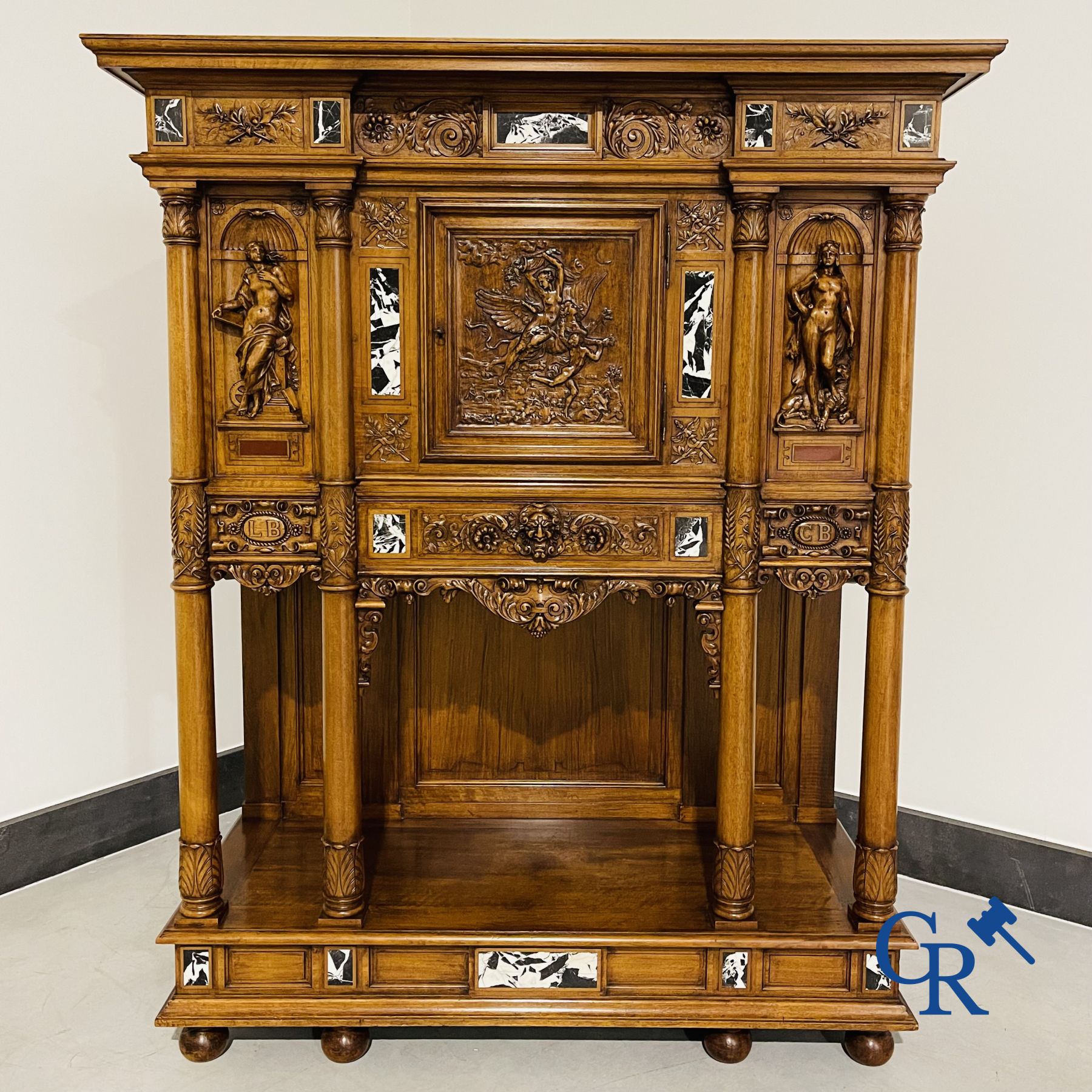 Furniture: A finely carved walnut credence in neo renaissance style with marble inlay.