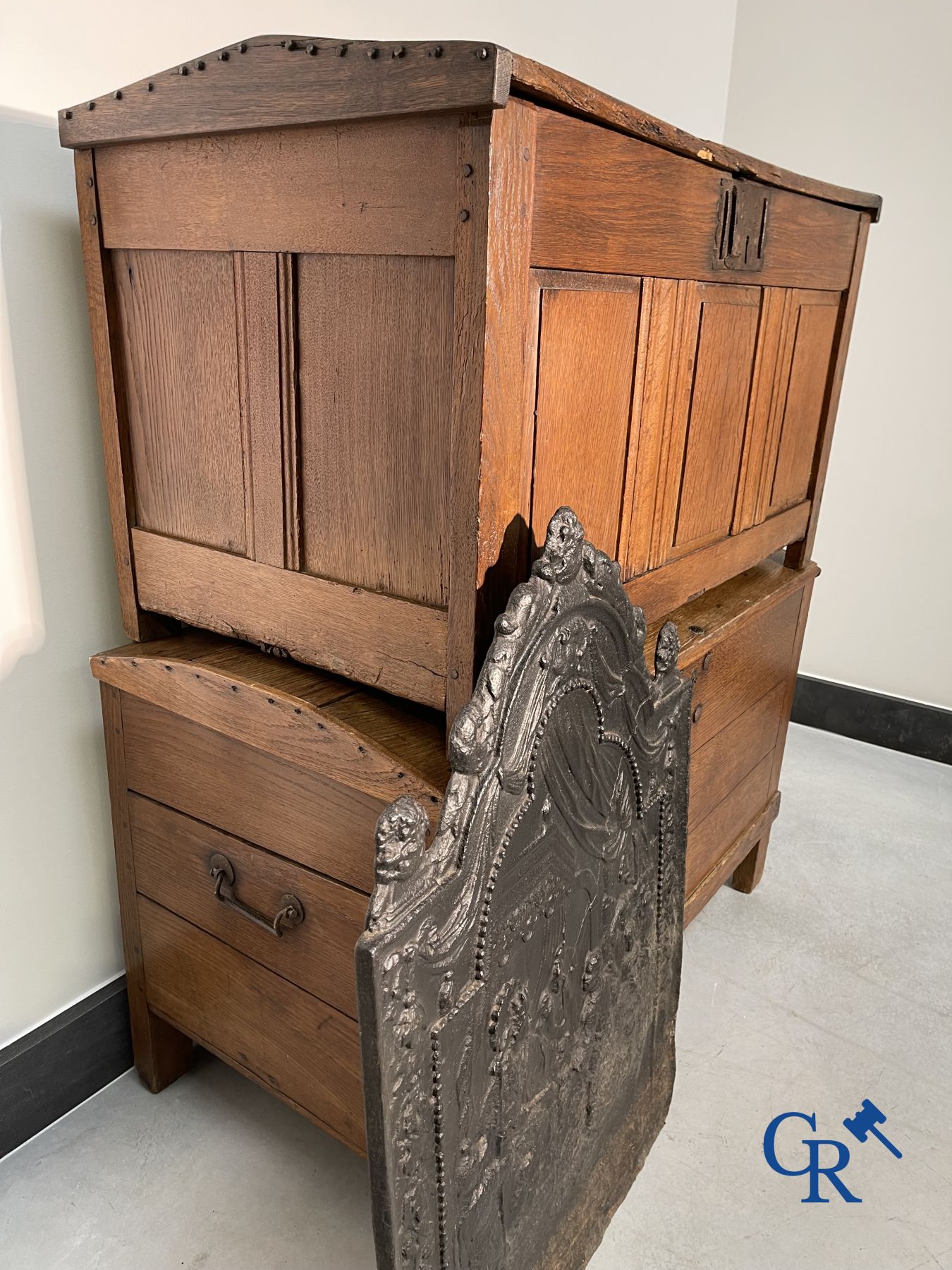 2 oak chests and an antique cast iron fireplace plate.