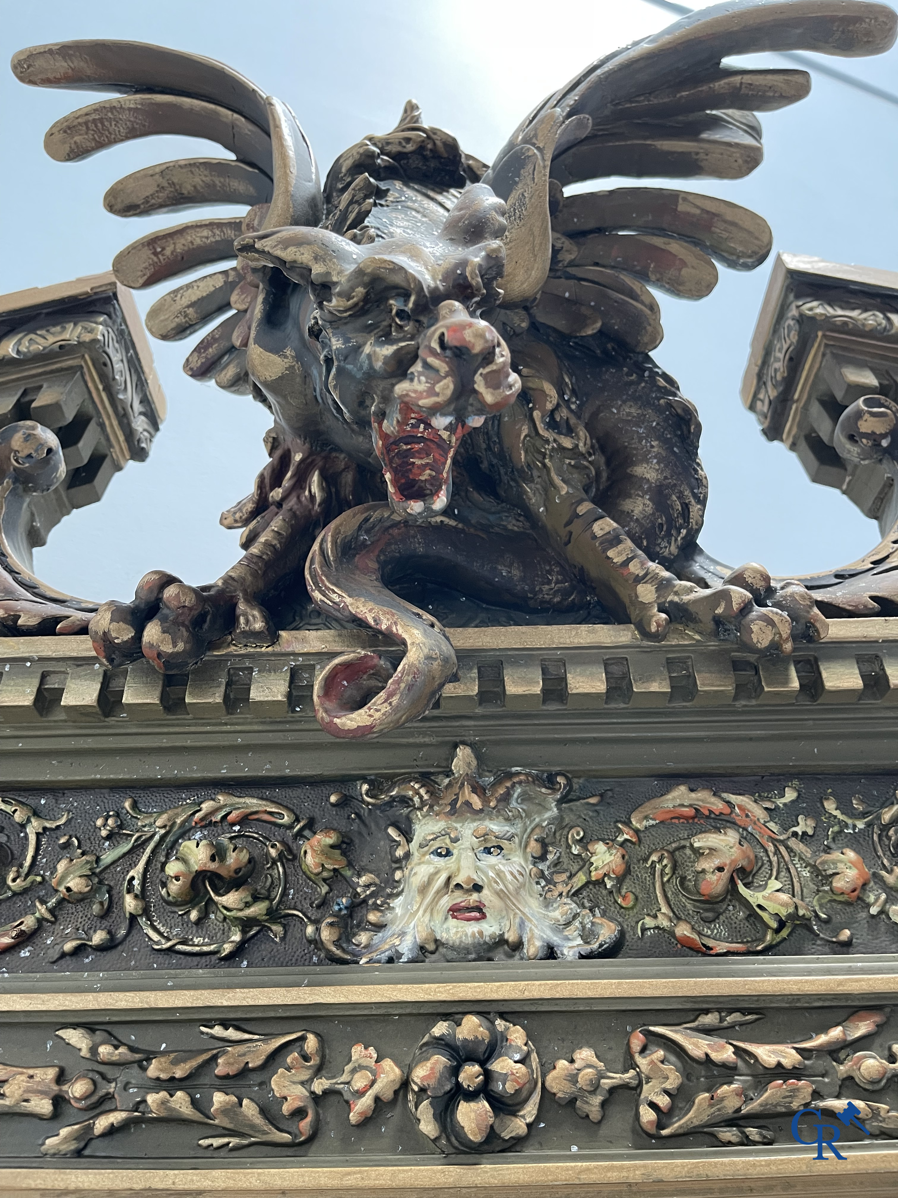 Un grand miroir de cheminée patiné avec un dragon. Vers 1900.