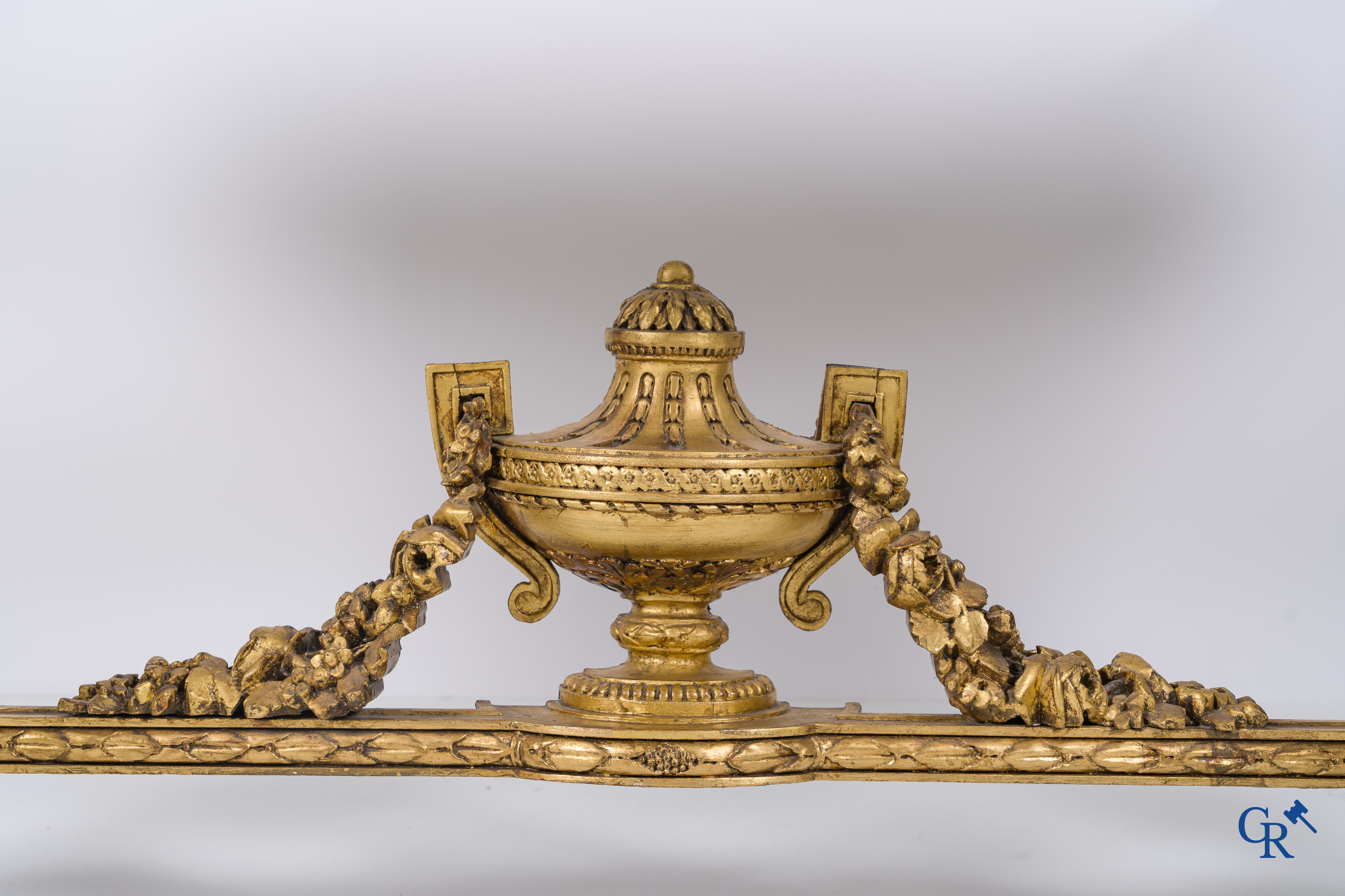 A richly carved and gilded console table in LVXI style with a grisaille painting on marble.