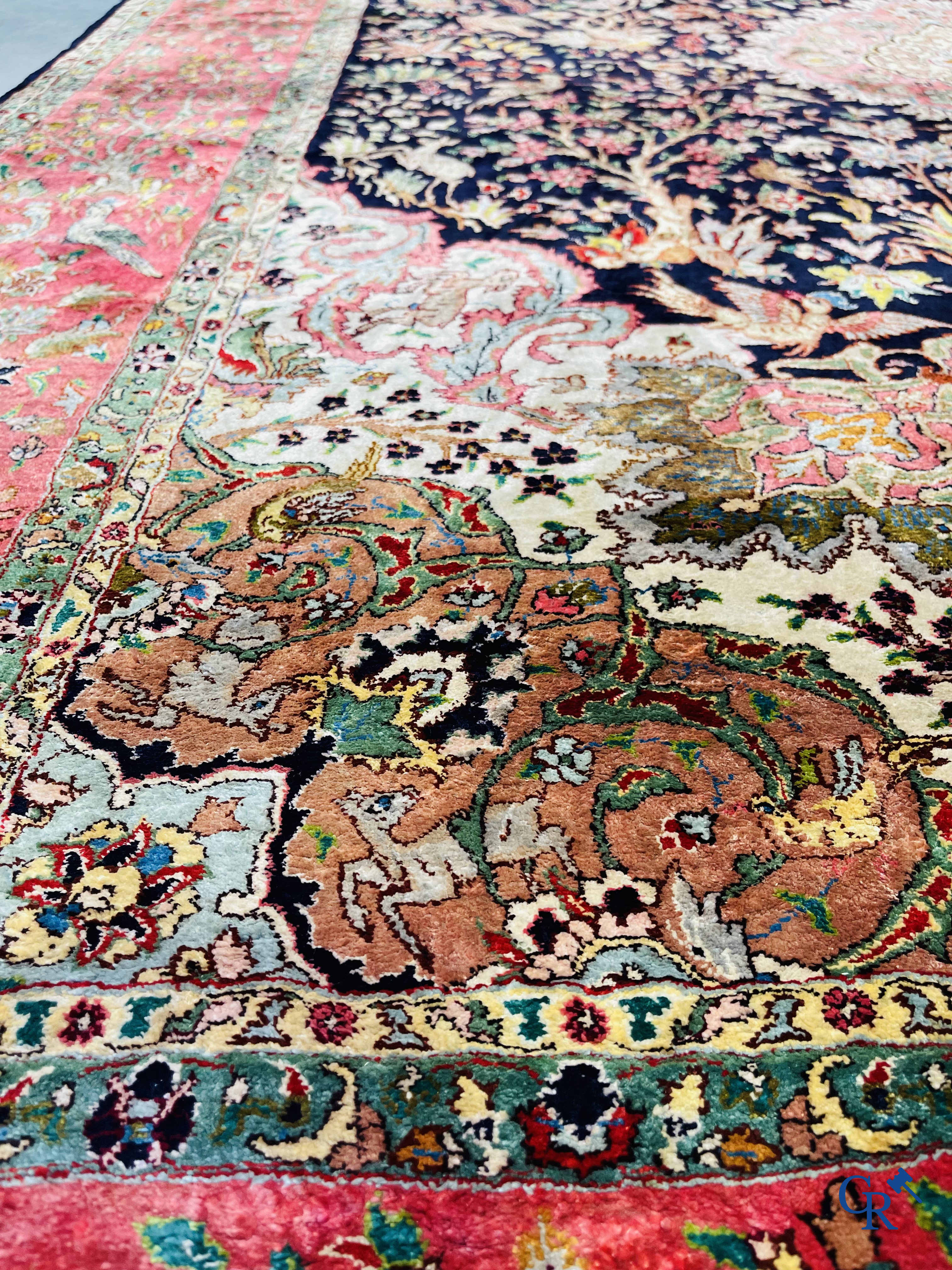 Oriental carpets: Tabriz, a finely hand-knotted silk carpet with forest animals and birds in a floral decor.