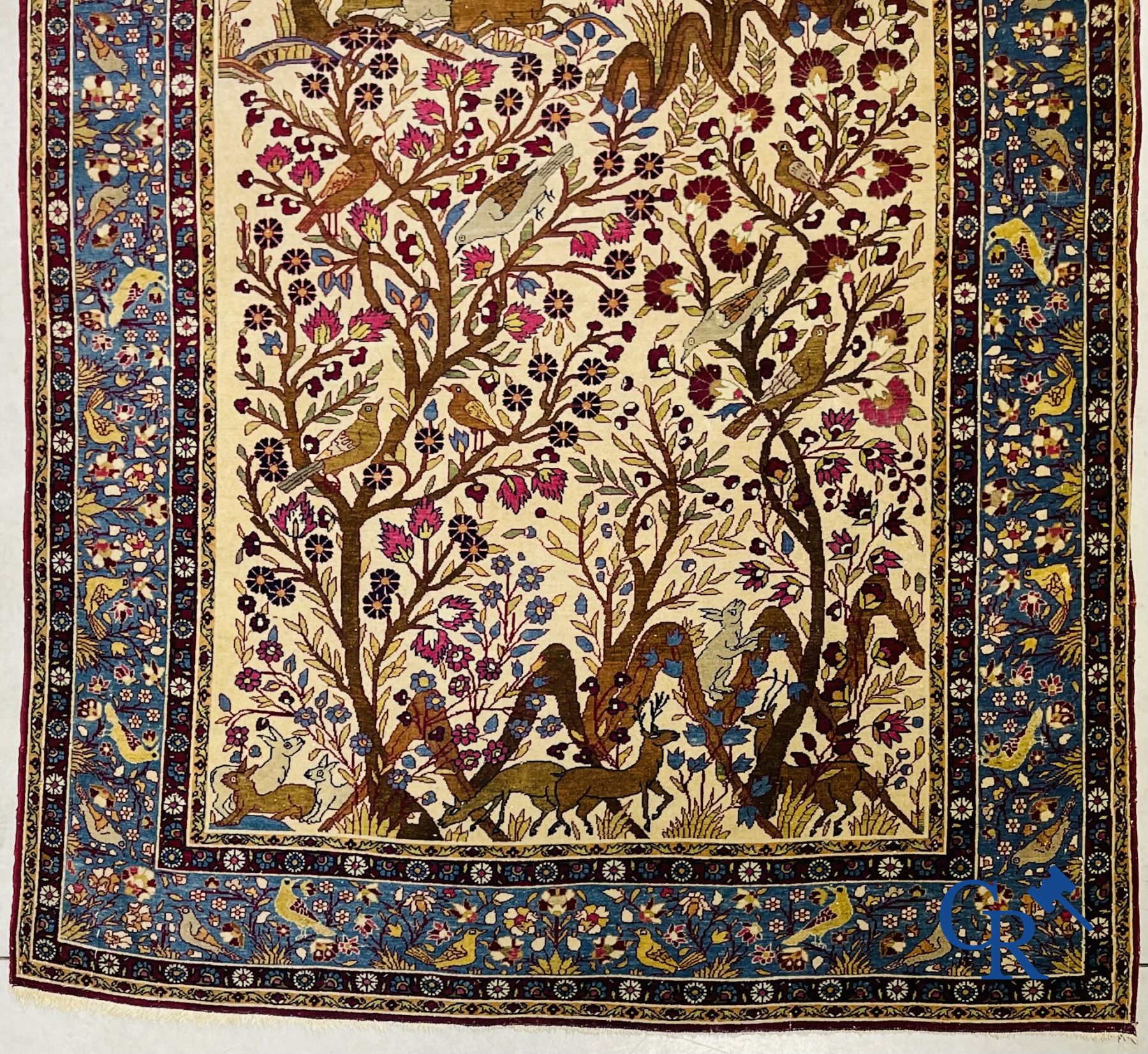 Oriental carpets: Antique oriental carpet with a decor of animals and birds in the forest.