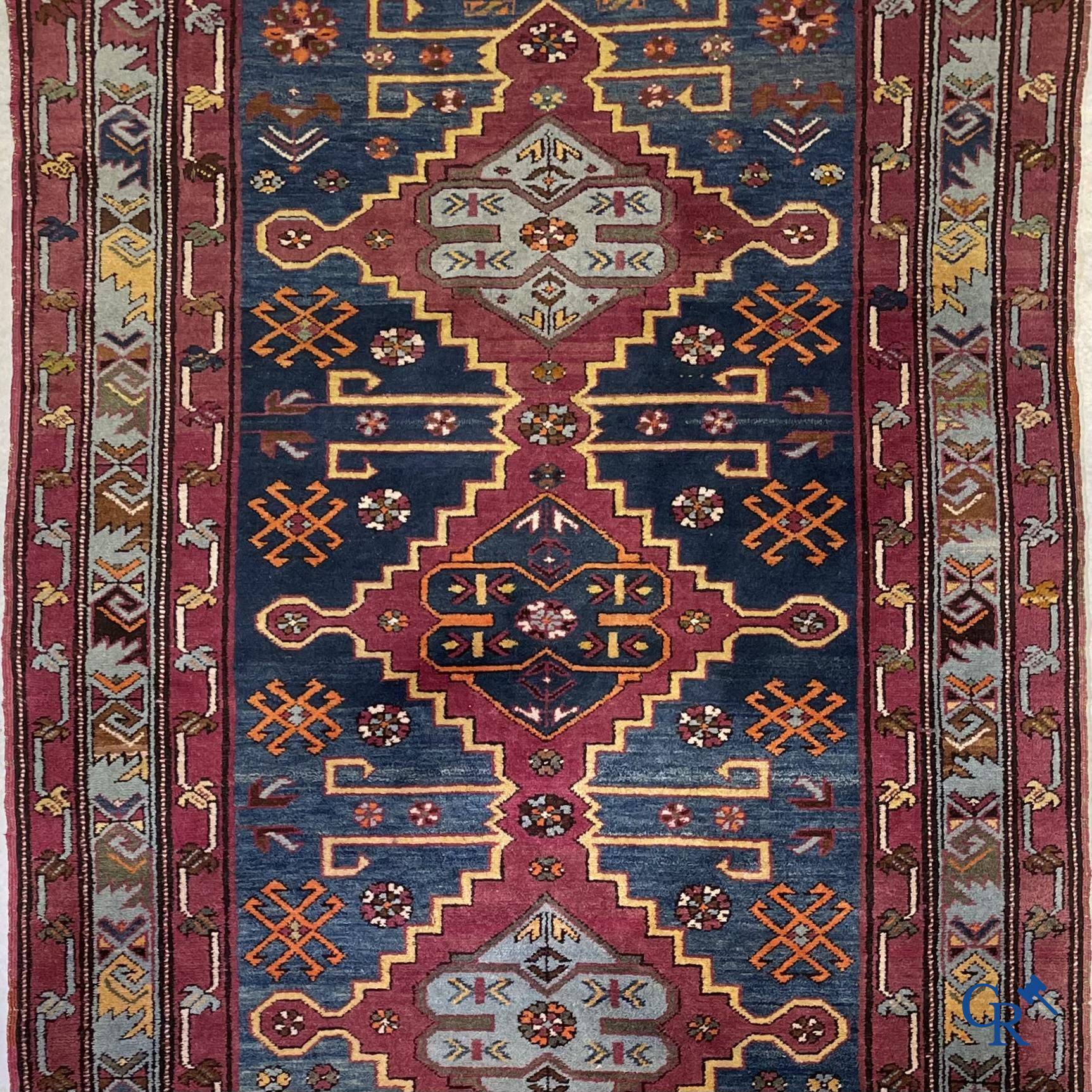 Oriental carpets, an antique hand-knotted Oriental carpet with motifs on a blue background.