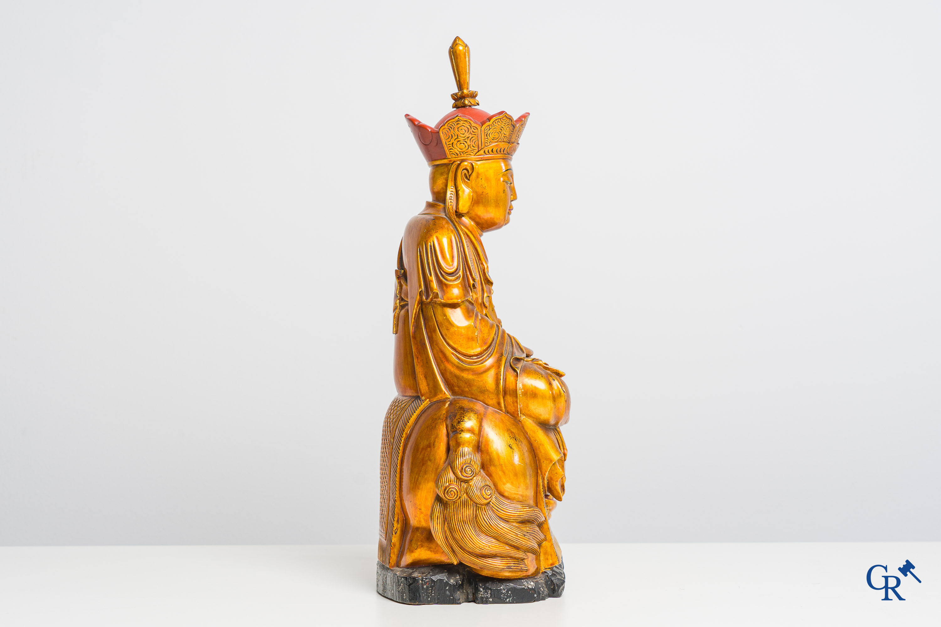 Asian Art: A Chinese sculpture of Vaishravana on a Buddhist lion in lacquered and gilded wood. 19th century.