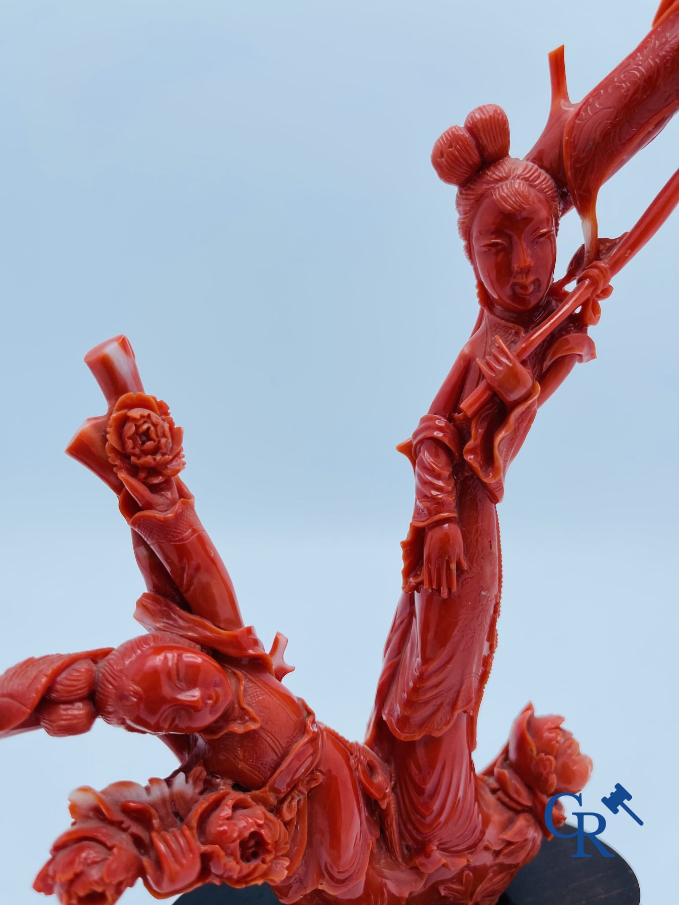 Asian Art: A Chinese group in red coral with ladies at a blossom branch. 19th century.