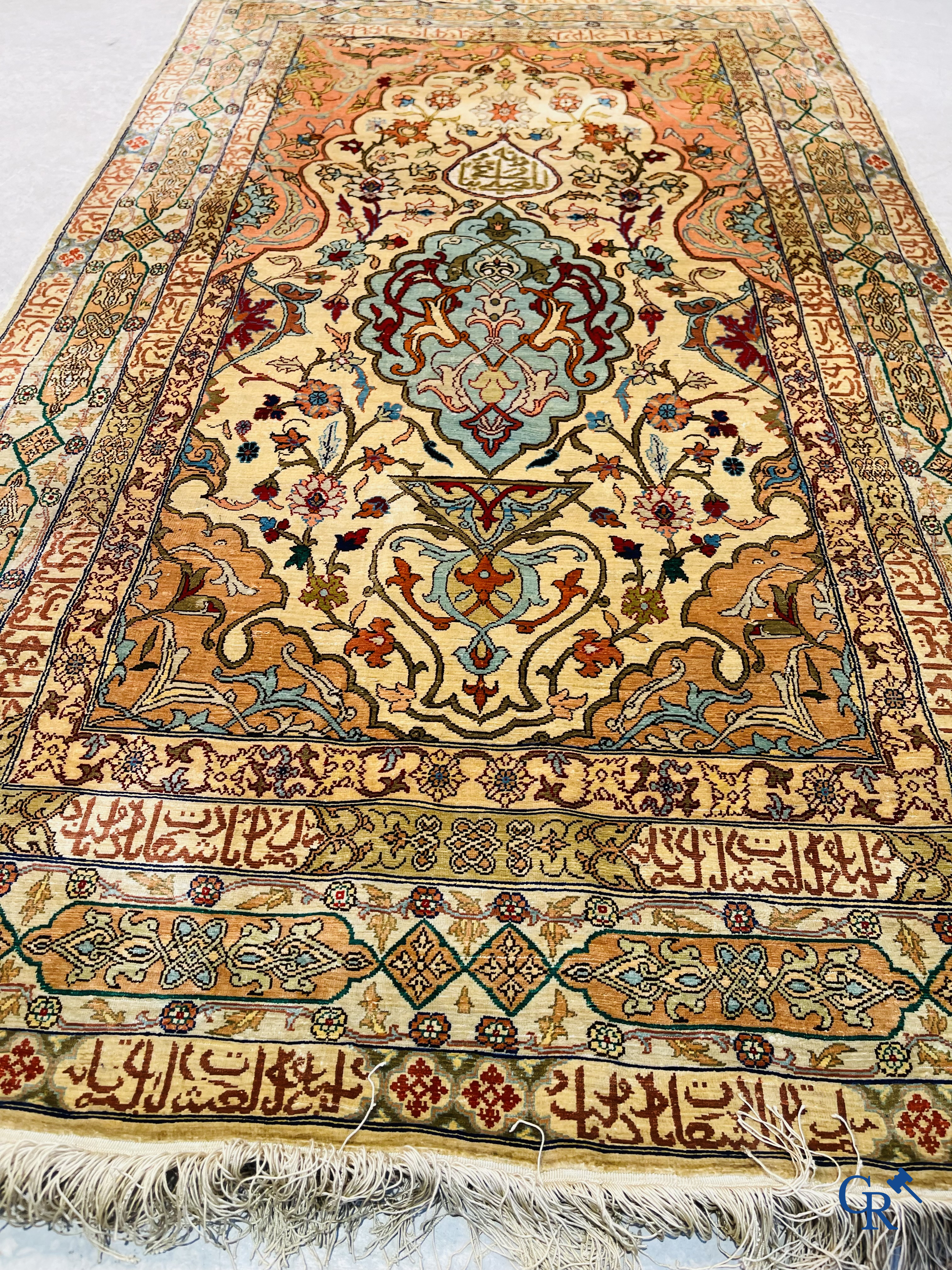 Oriental carpets, Hereke Turkey, a finely hand-knotted silk carpet with inscriptions and gold thread.