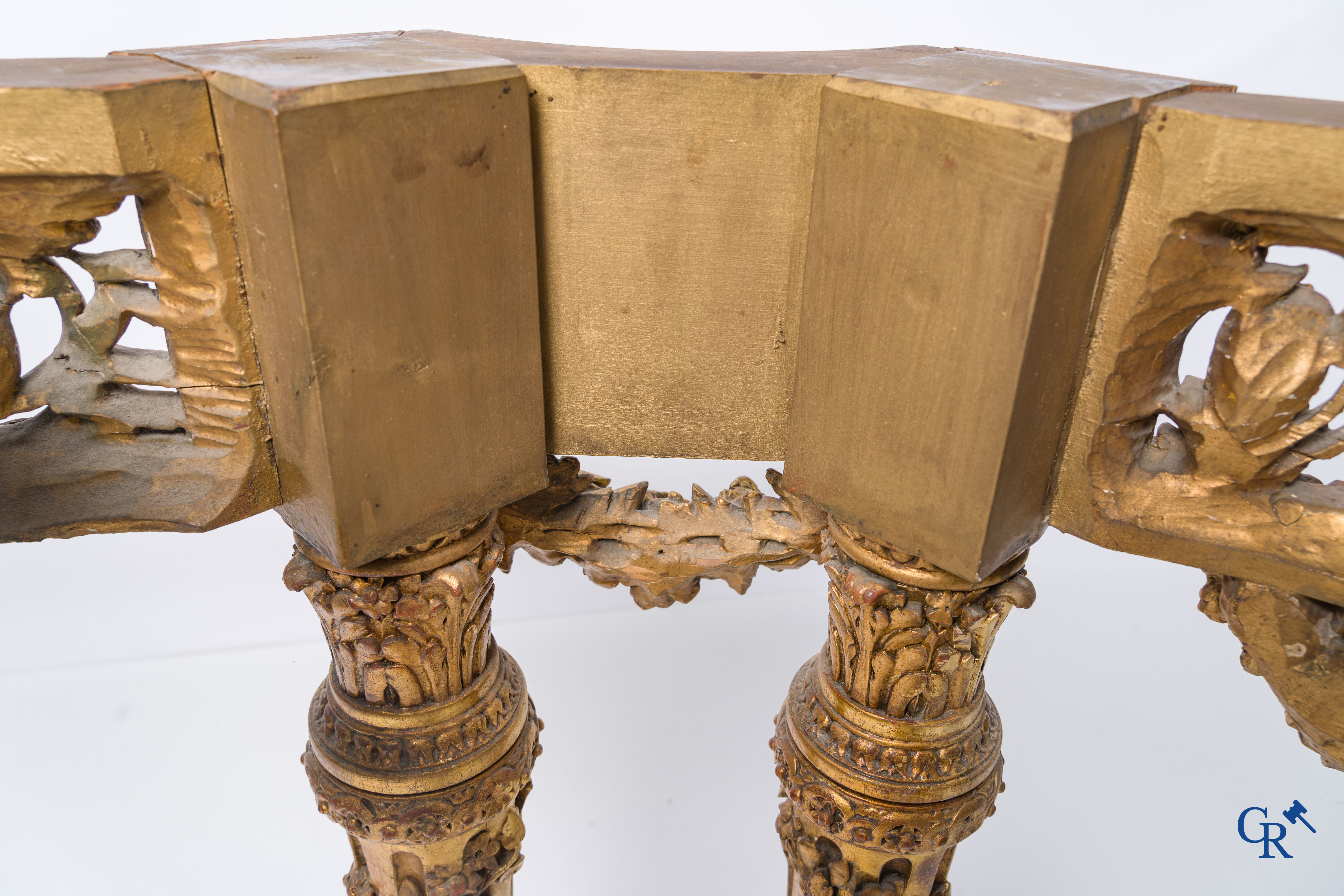 A richly carved and gilded console table in LVXI style with a grisaille painting on marble.