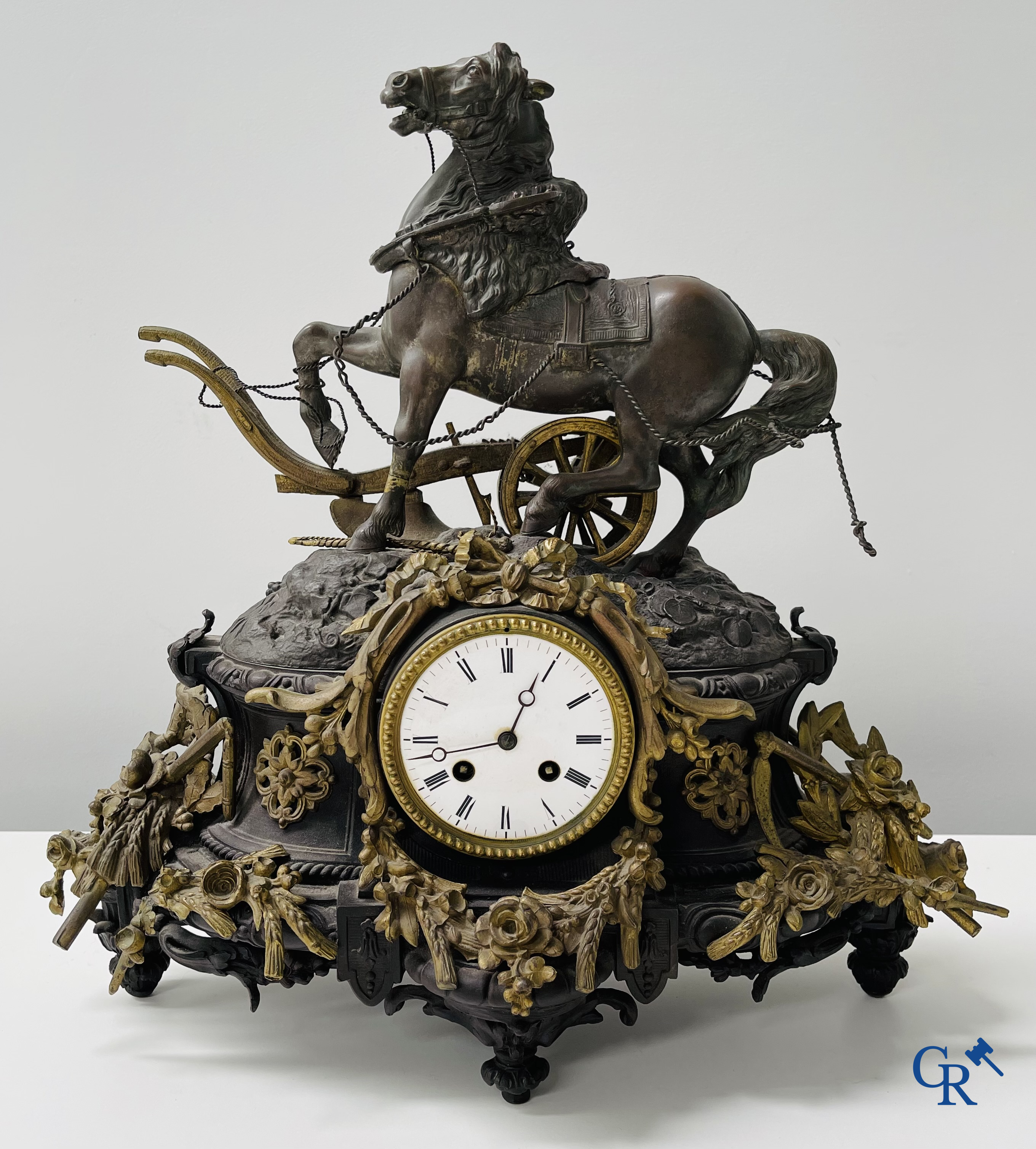 A lot with a clock in spelter, a pair of statues in Royal Dux and a french wedding dome globe.