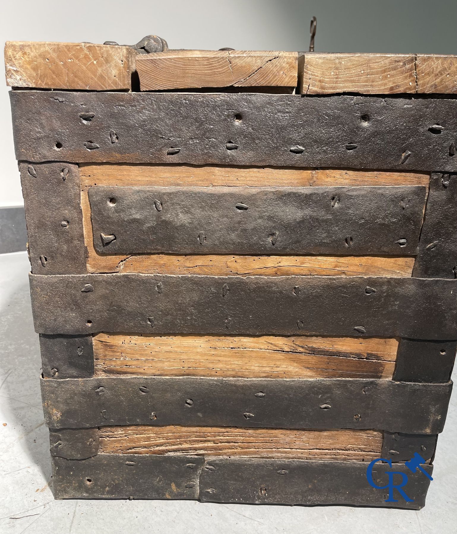 Antique wooden chest with hardware and lockwork in forging.