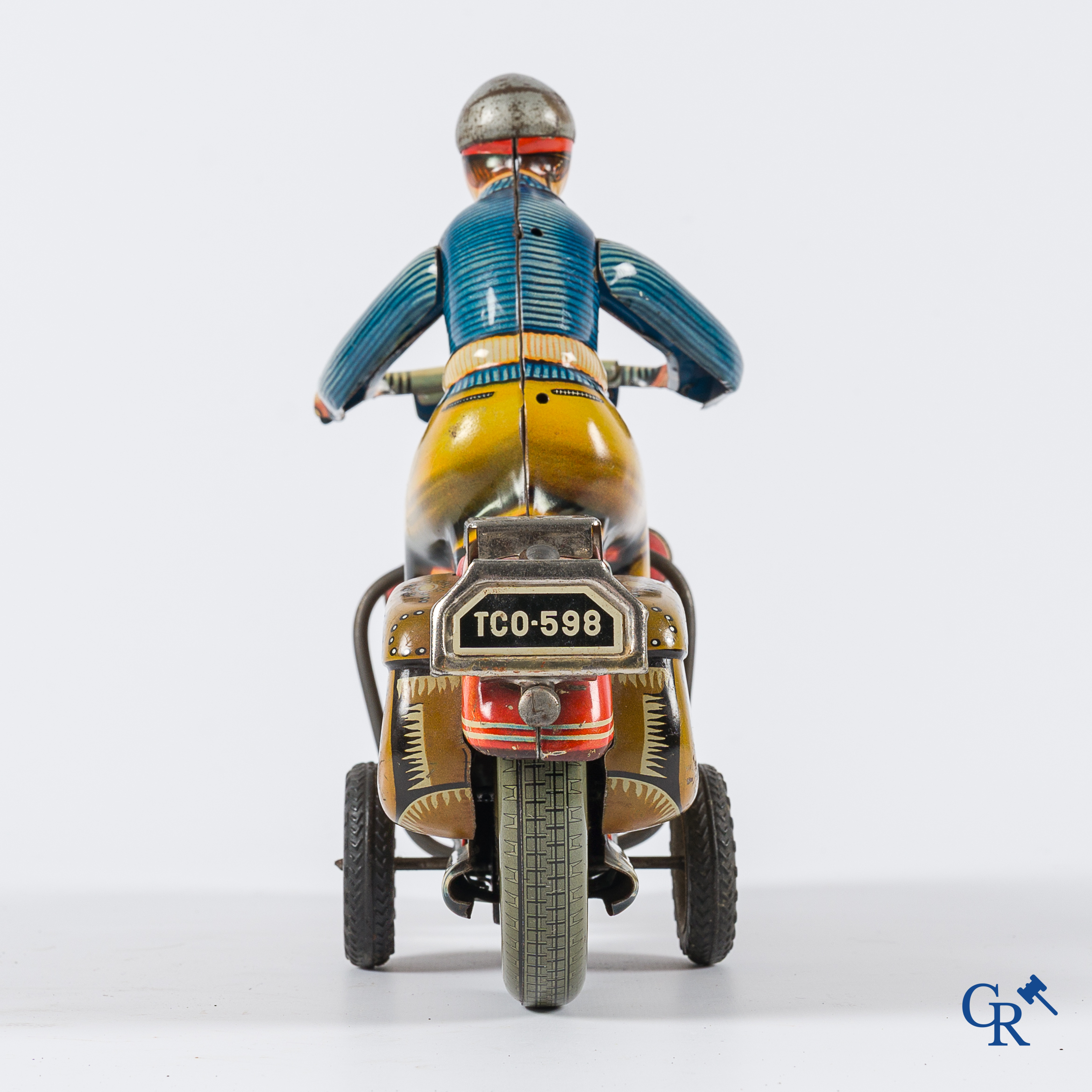 Oud speelgoed. Tipco, Western Germany. Motorfiets in beschilderd blik. Jaren '50.