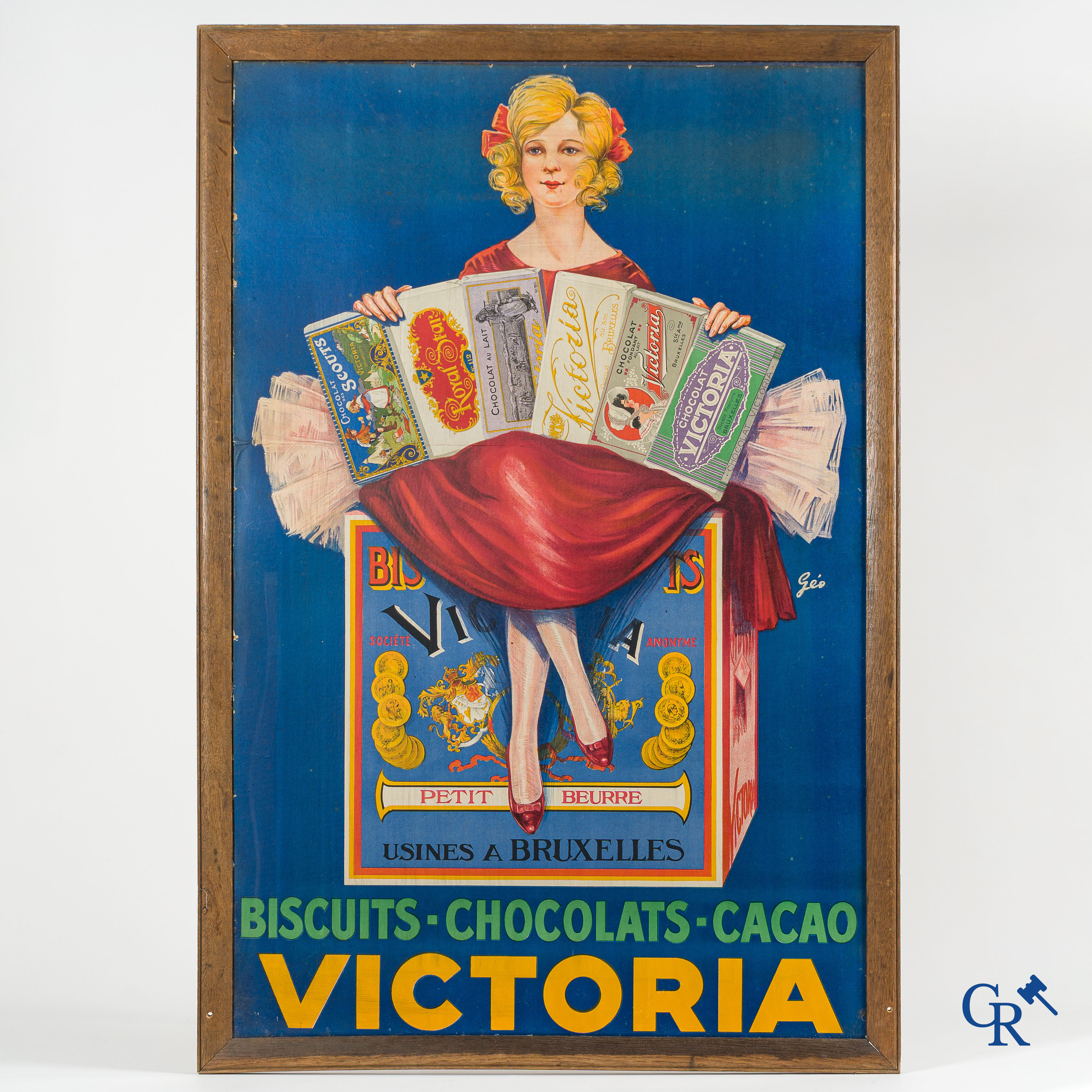 Géo. Grote ingekaderde publiciteit op karton voor de producten van de S.A. Victoria te Brussel.