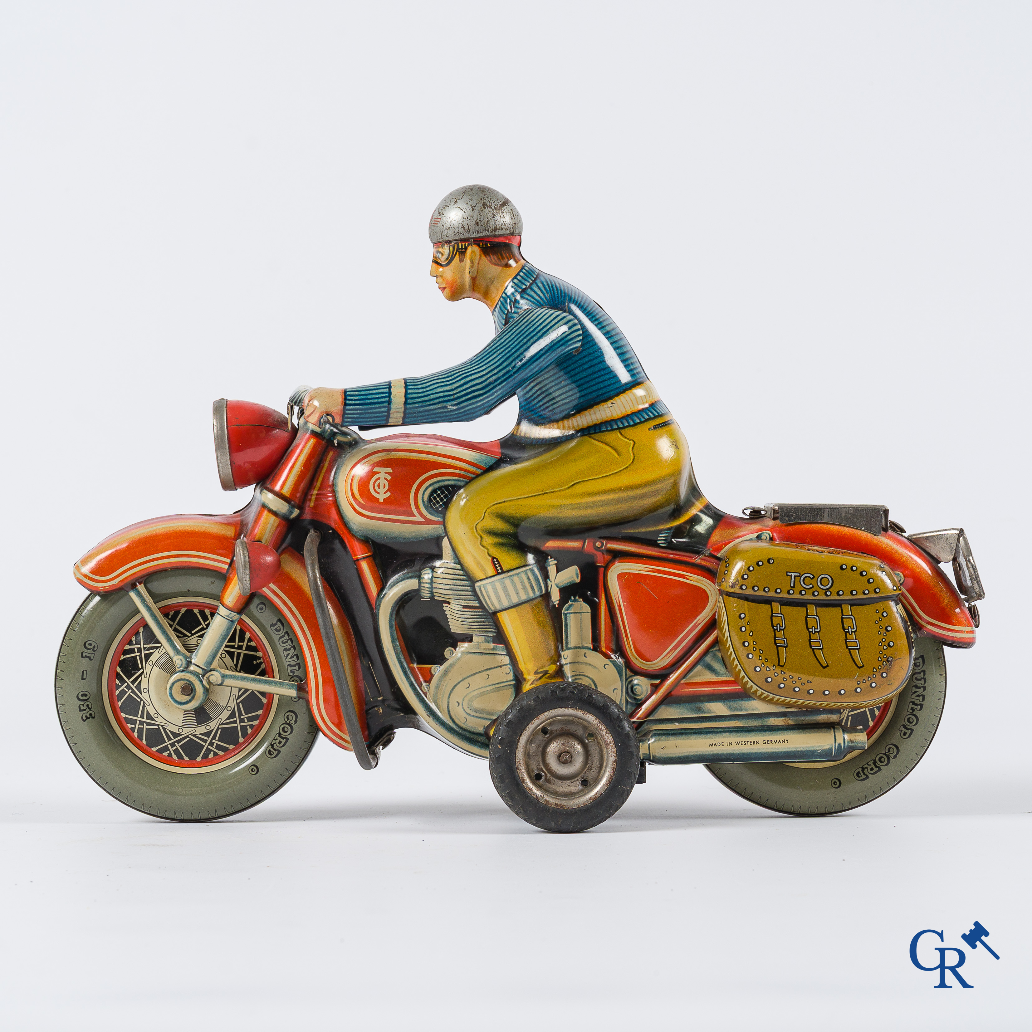 Oud speelgoed. Tipco, Western Germany. Motorfiets in beschilderd blik. Jaren '50.