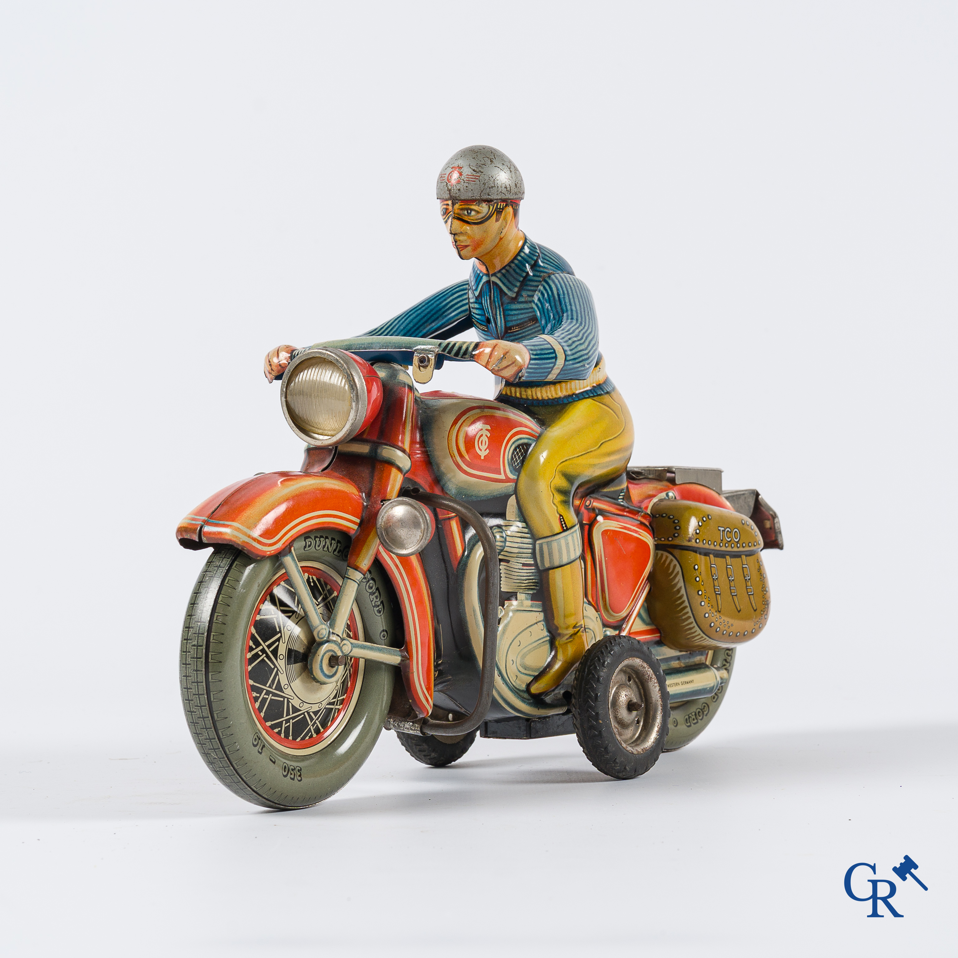 Oud speelgoed. Tipco, Western Germany. Motorfiets in beschilderd blik. Jaren '50.