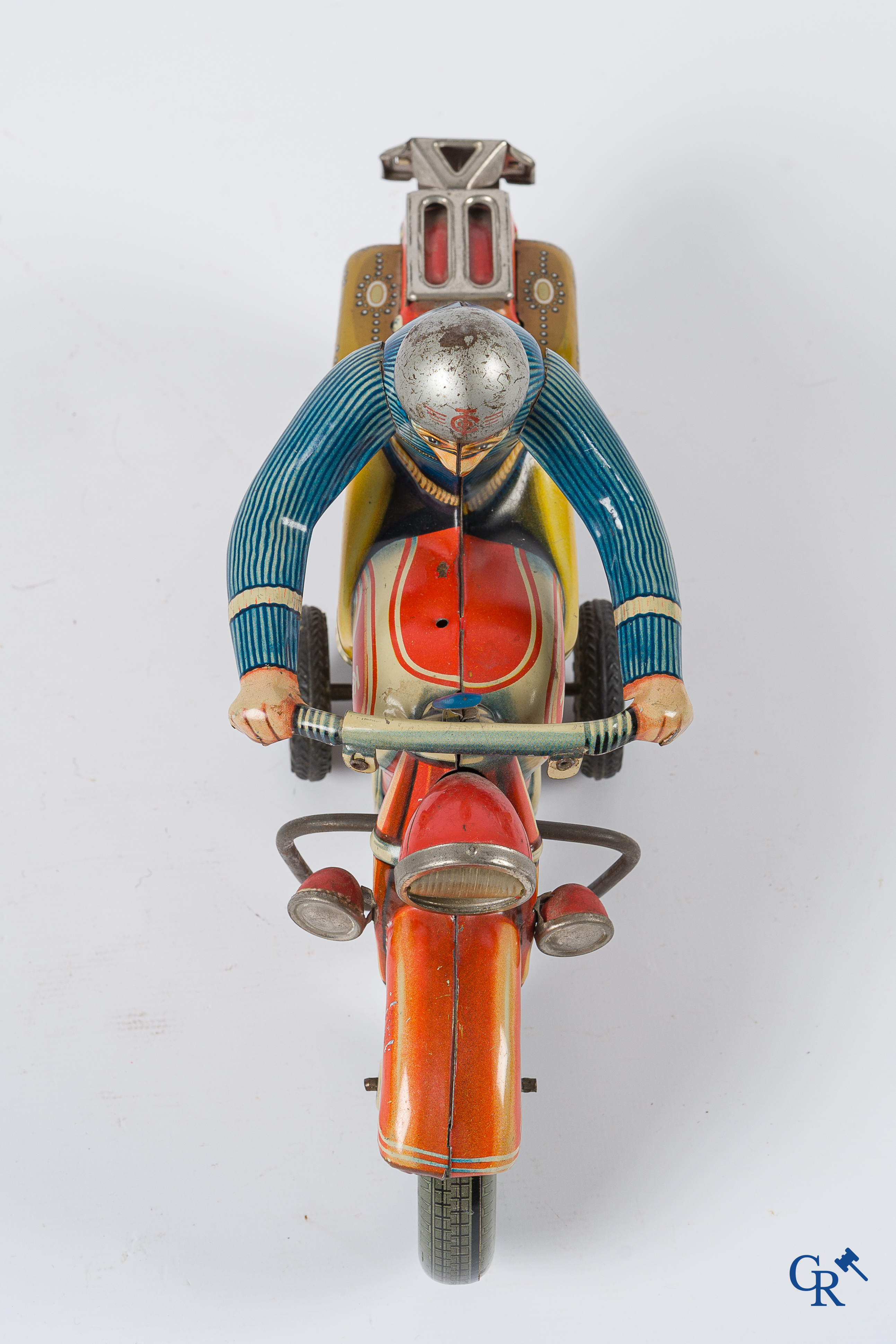 Oud speelgoed. Tipco, Western Germany. Motorfiets in beschilderd blik. Jaren '50.