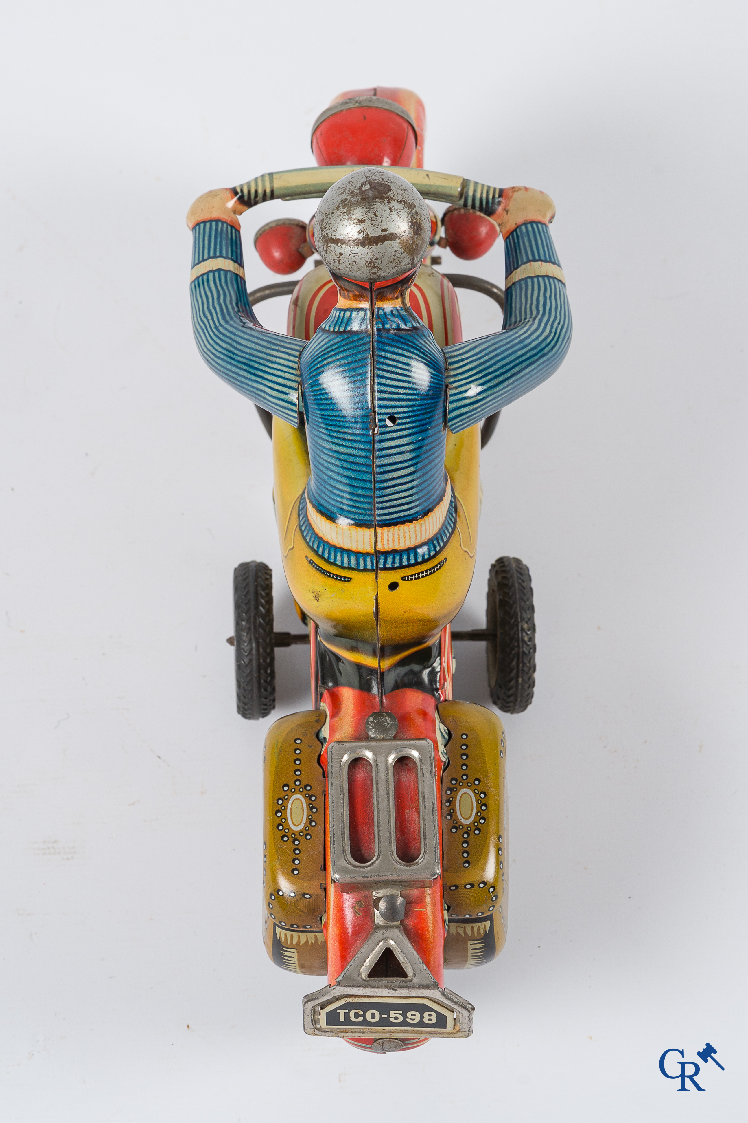 Oud speelgoed. Tipco, Western Germany. Motorfiets in beschilderd blik. Jaren '50.